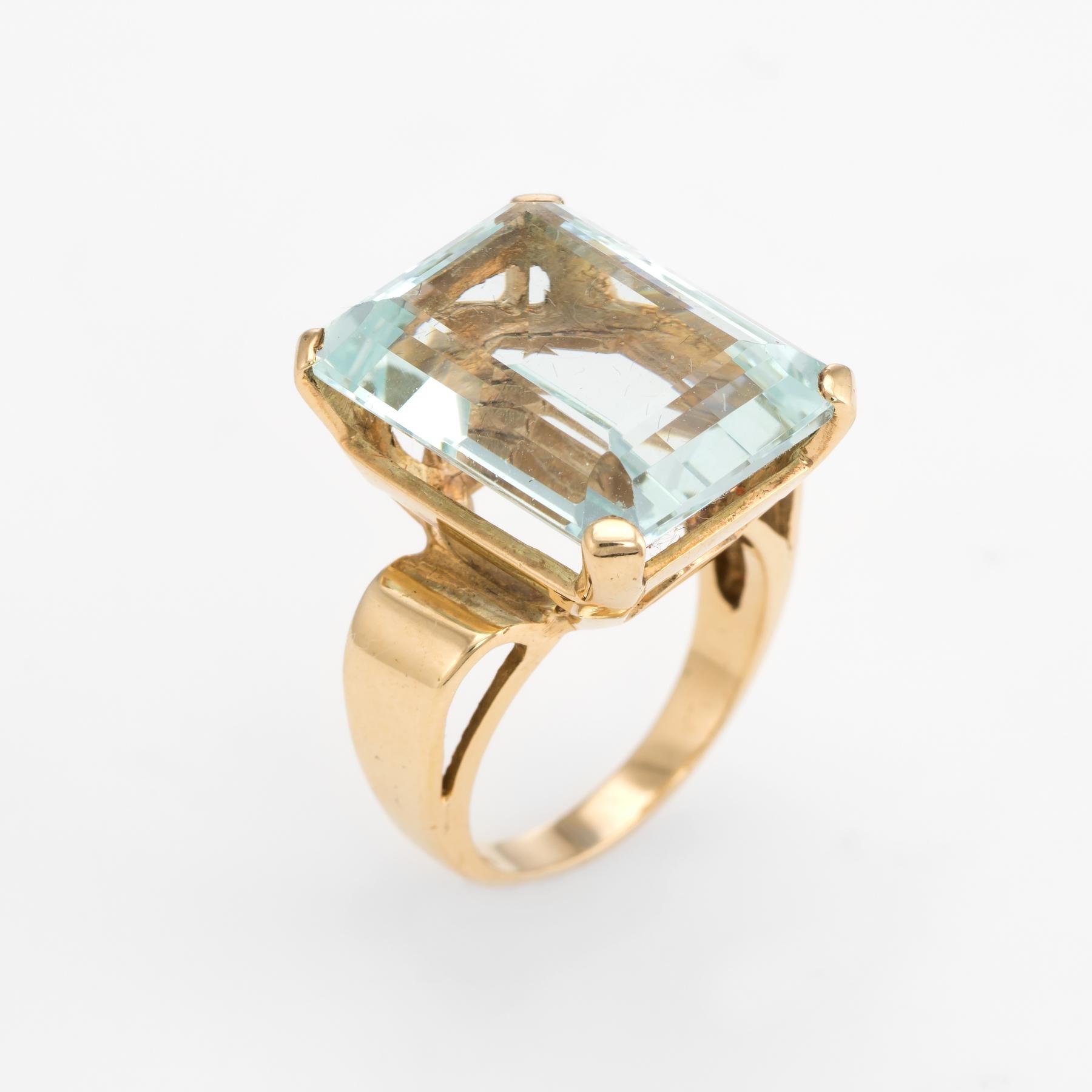 Elegant vintage aquamarine cocktail ring (circa 1970s to 1980s), crafted in 14 karat yellow gold. 

Centrally mounted emerald cut aquamarine measures 18mm x 13mm (estimated at 17 carats). The aquamarine is in excellent condition and free of cracks