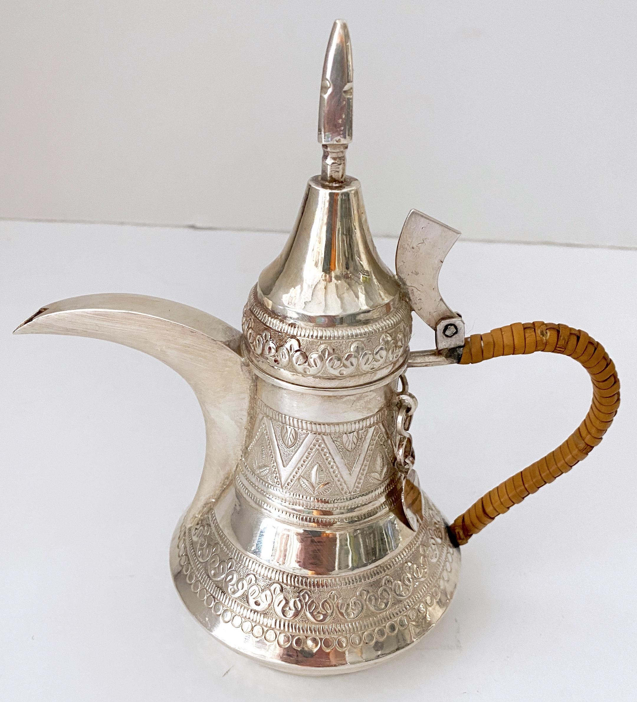 Vintage Arabic /Middle Eastern Silverplated Dallah Coffee Pot 
20th century 1950s/60s

Nicer than most examples, with bright silverplating, all over engraved decoration. Complete with a woven reed handle. Unmarked. 



.