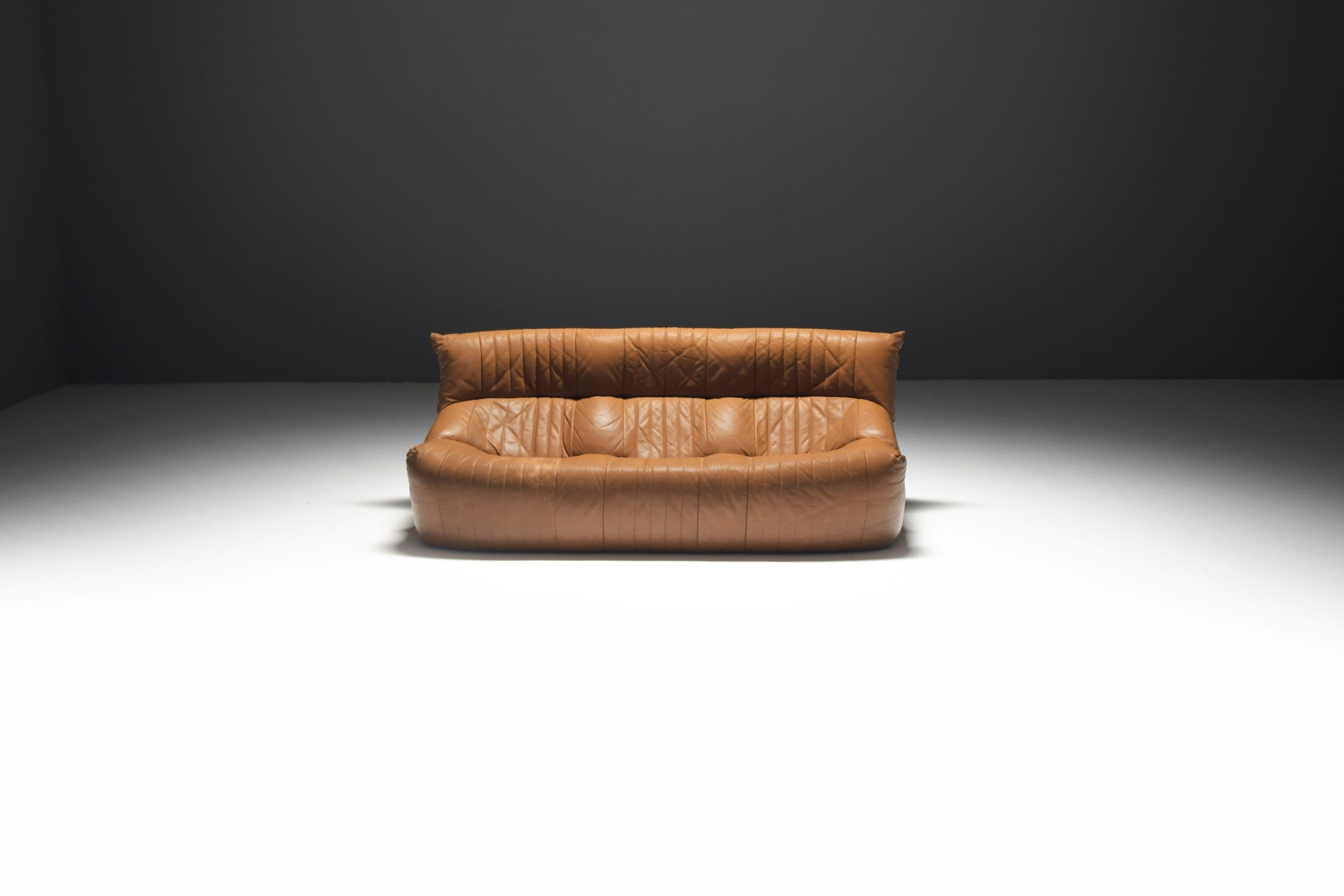 A beautifully designed and stylish 'Kashima' sofa in its original cognac leather, offering both elegance and exceptional comfort. Created by renowned designer Michel Ducaroy, best known for his iconic 'Togo' design, this piece showcases his