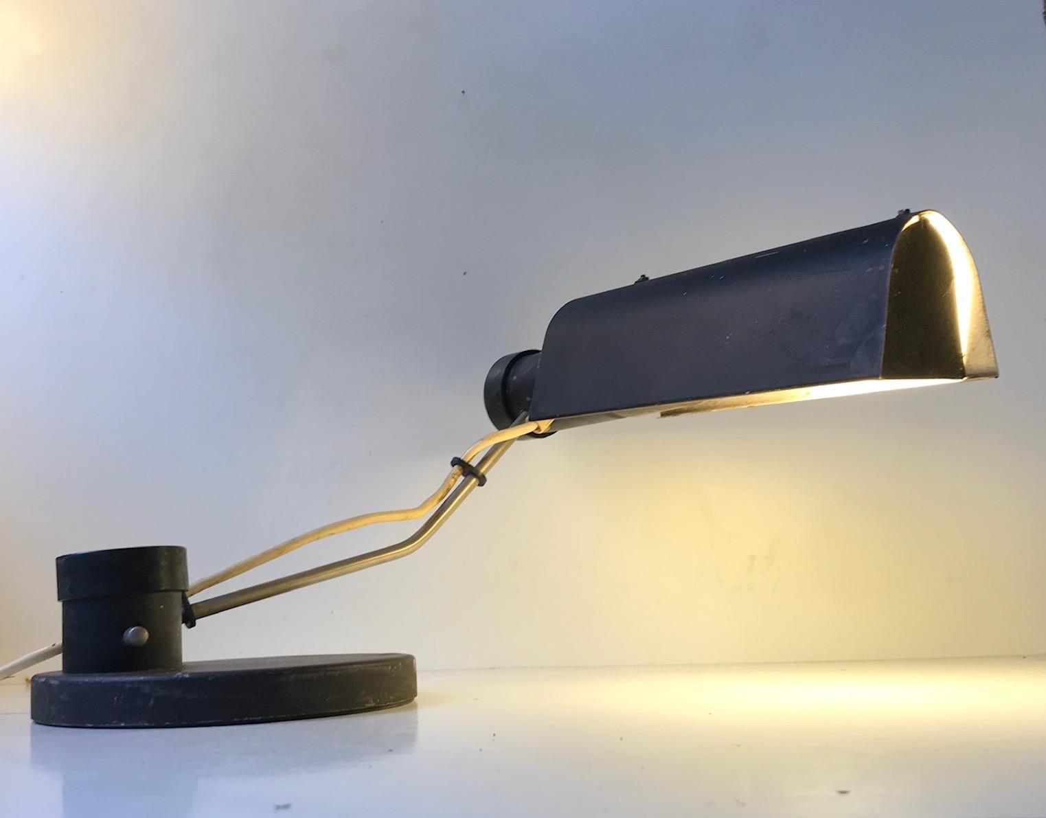 Low riding yet fully adjustable table lamp model TK 501, produced by VEB Metalldruecker in Halle, DDR during the 1960s. Original condition, unrestored, and with ware and patina.