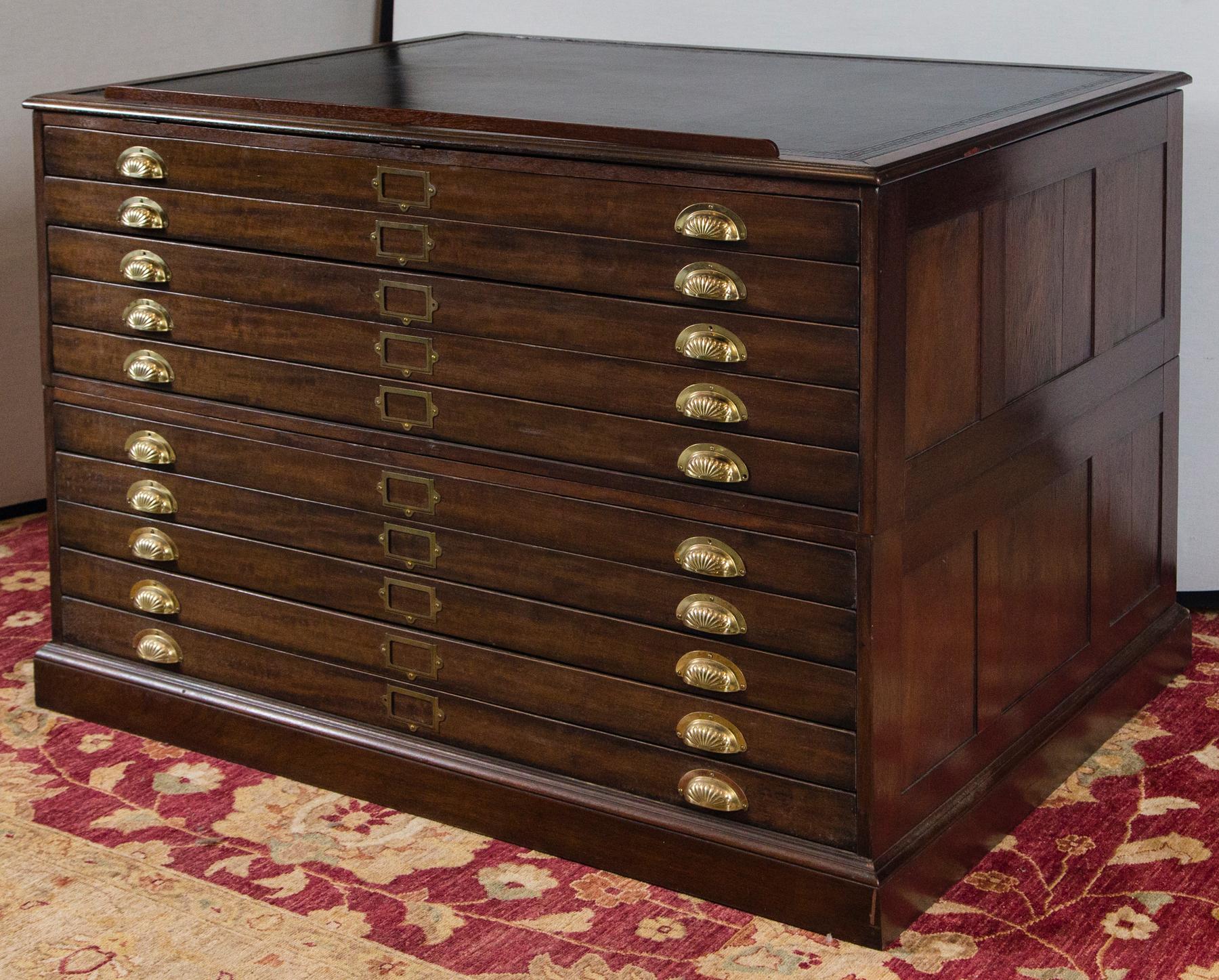 Unique Architect's plans cabinet with lift-top black leather top. Leather has some wear and scratches but is not torn. Leather has a Greek key tooling. This is a two piece construction with 5 drawers on each section. A great functional piece to