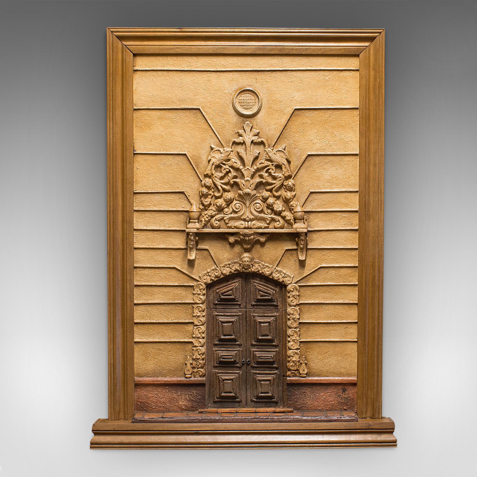 This is a vintage architectural plaque. An Italian, plaster mixed-media decorative Baroque doorway, dating to the mid-20th century, circa 1950.

Fascinating architectural display piece
Displays a desirable aged patina
Plaster and mixed-media in