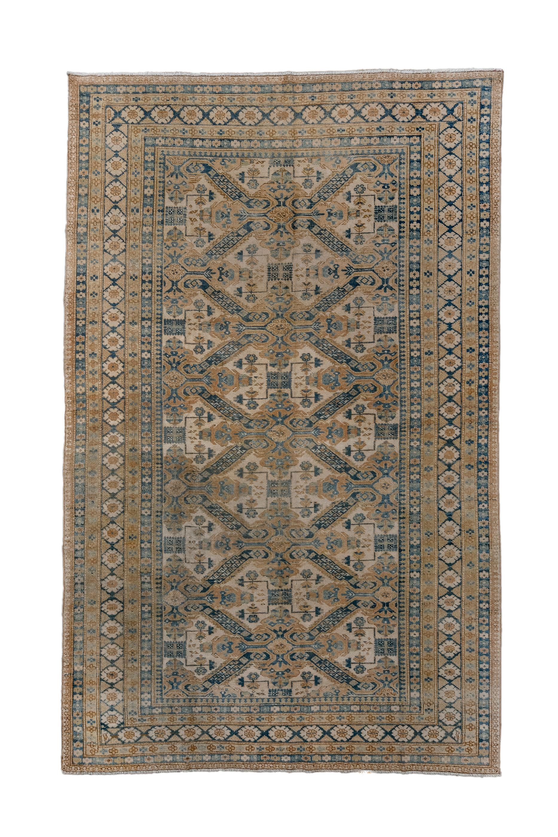 Ardebil rugs are a post WWII innovation, employing Caucasian designs, especially, as here, those of Kuba and Shirvan, but of Persian origin and facture. The sandy straw field shows a St. Andrews Cross Zeychur design.  The main royal blue border