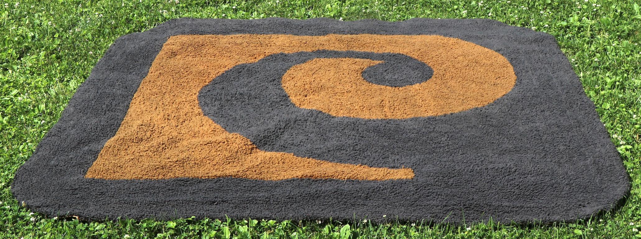 Chic, stylish and sophisticated area rug having the iconic Cardin PC logo in grey on warm tan brown ground. Vintage 1970s-1980s period, in good original condition. We have seen several Pierre Cardin rugs and carpets, but this is the first one we