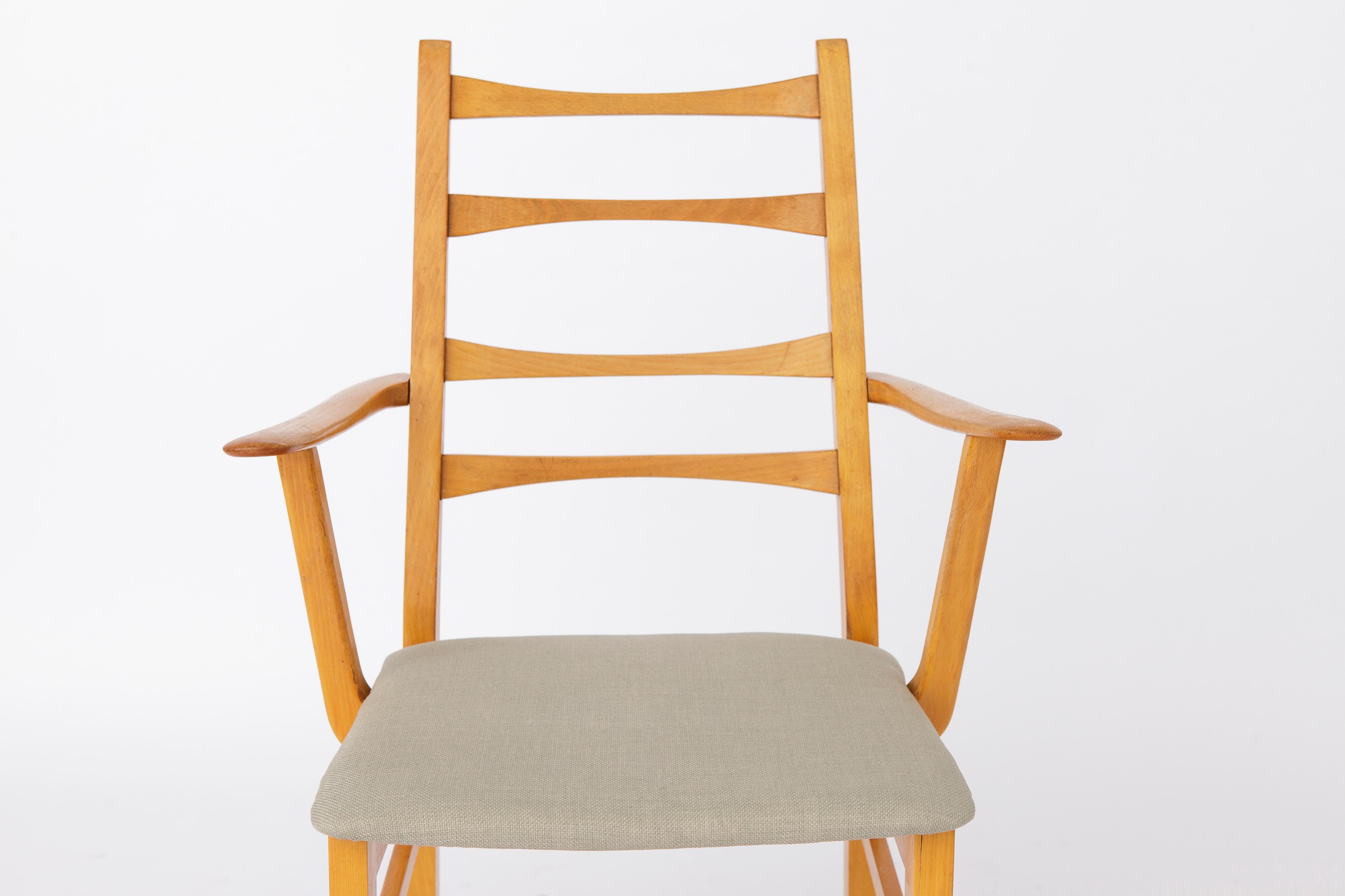 Vintage Armchair from the 1960s. 
German origin. Unknown manufacturer. 
Just 1 available. Fits perfectly to previous set of 4 vintage chairs. 

Sturdy beech wood frame. Refurbished and oiled. 
Seat reupholstered with light green textile cover.