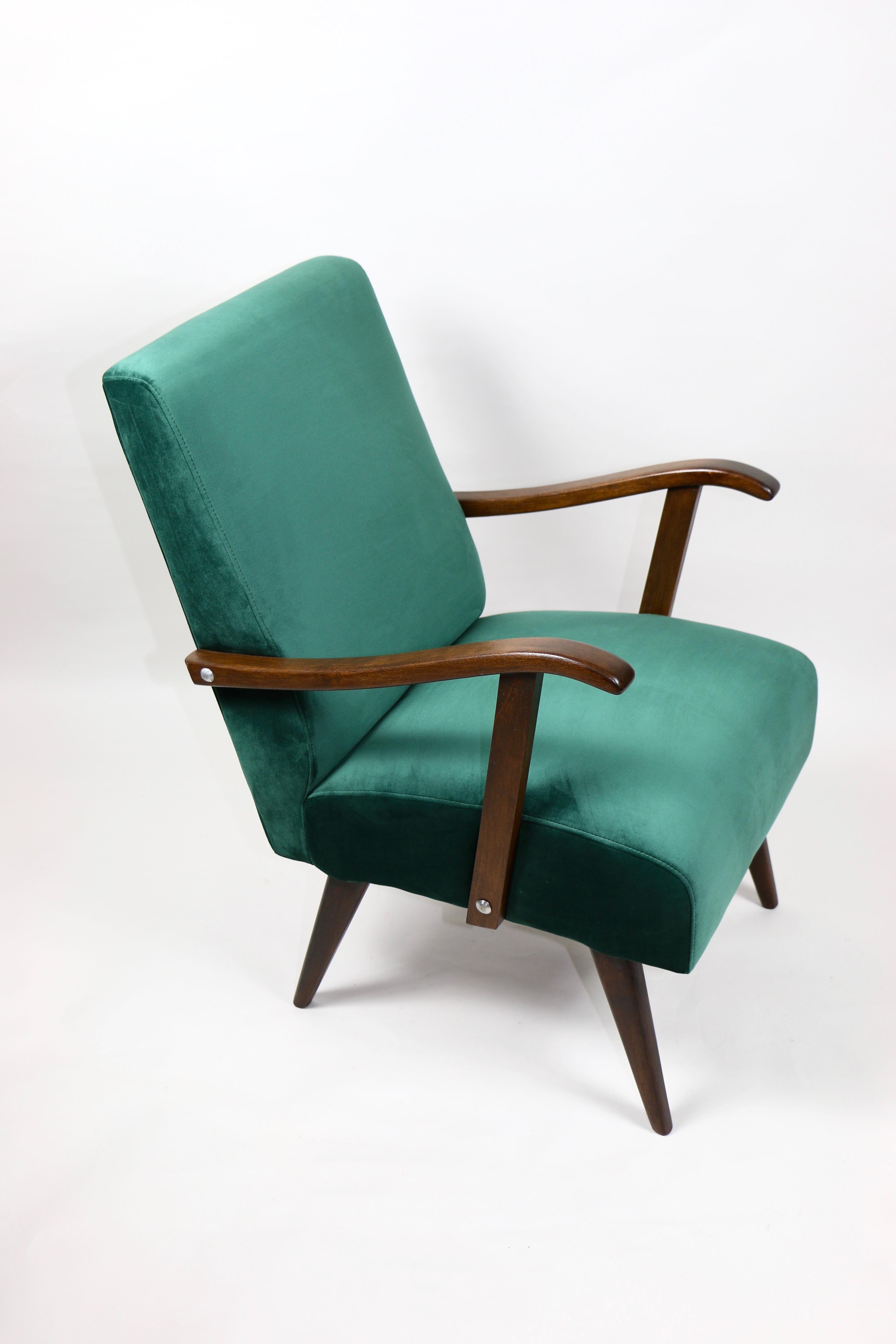 Vintage club armchair design in green made velvet from 1970s, new upholstery covered with velvet fabric in fashionable green color, finished with wooden chair cushion. Wooden elements in dark oak color. Perfect condition. This model is one of the