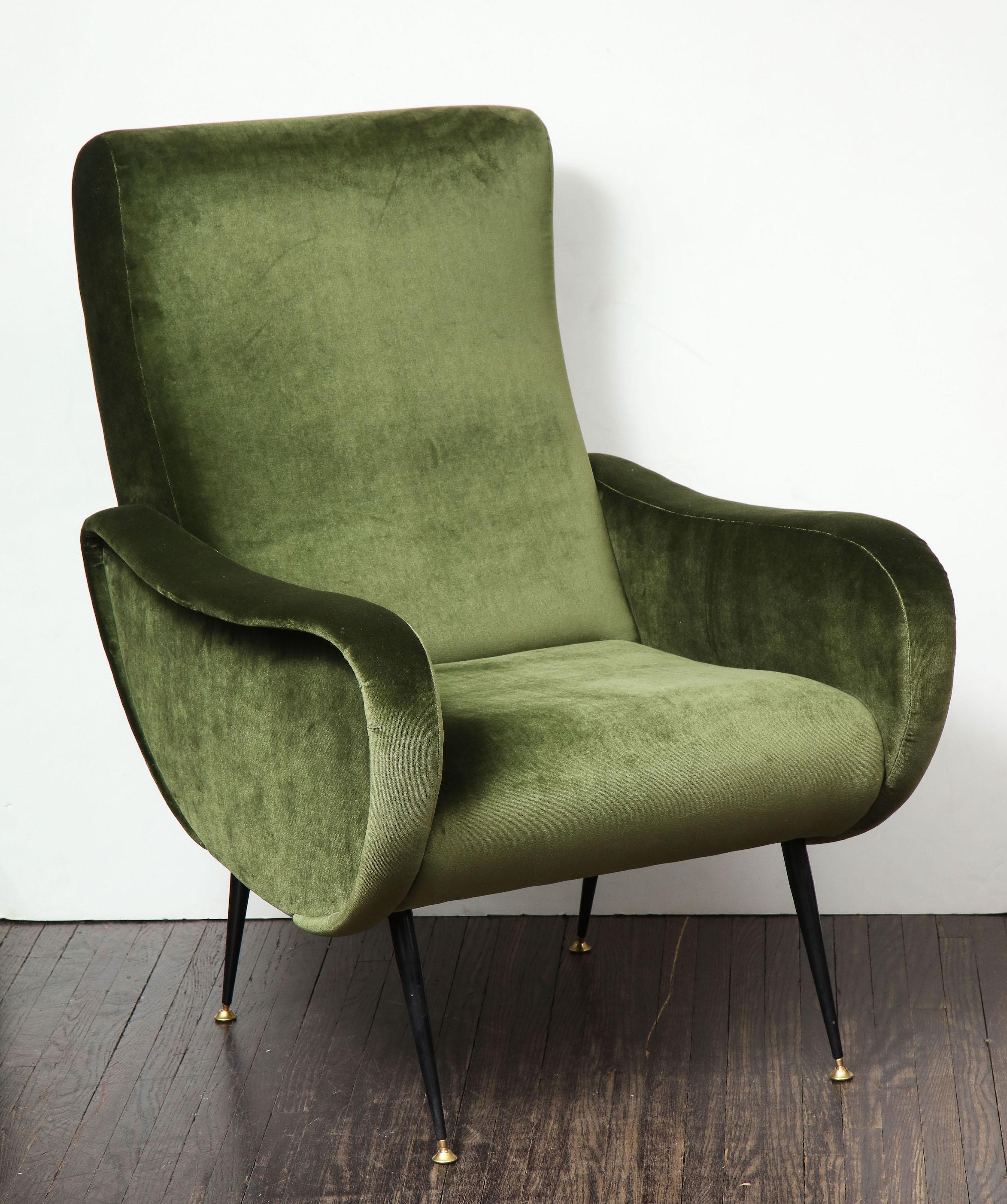 A beautiful single vintage armchair in the style of Marco Zanuso in green velvet. The chair is newly upholstered and has the original iron legs with brass caps.