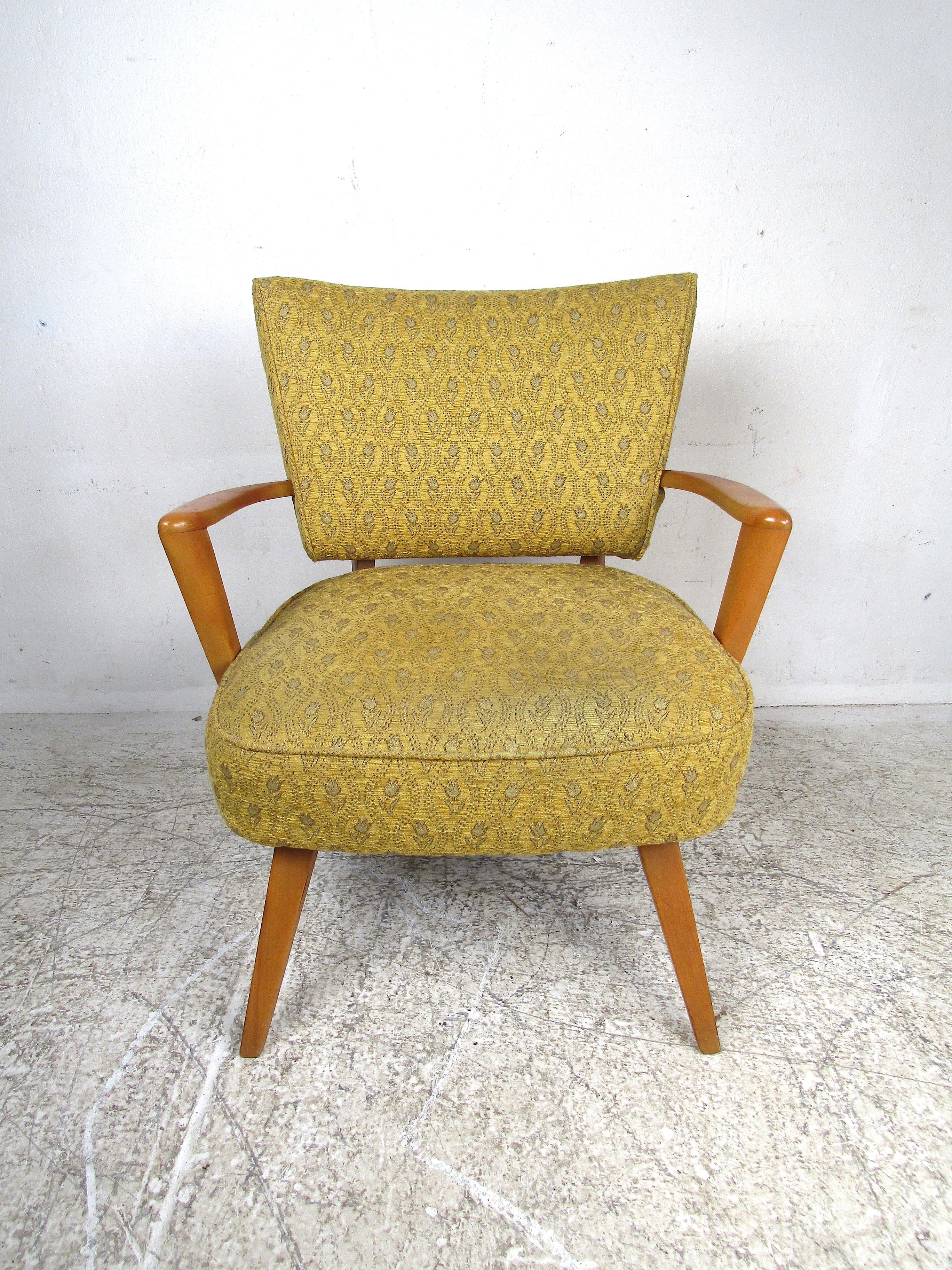 Petite vintage armchair with a floral pattern upholstery. Handsome frame with sculpted armrests and splayed legs. Large cushioned seat with a contoured backrest. Please confirm item location with dealer (NJ or NY).