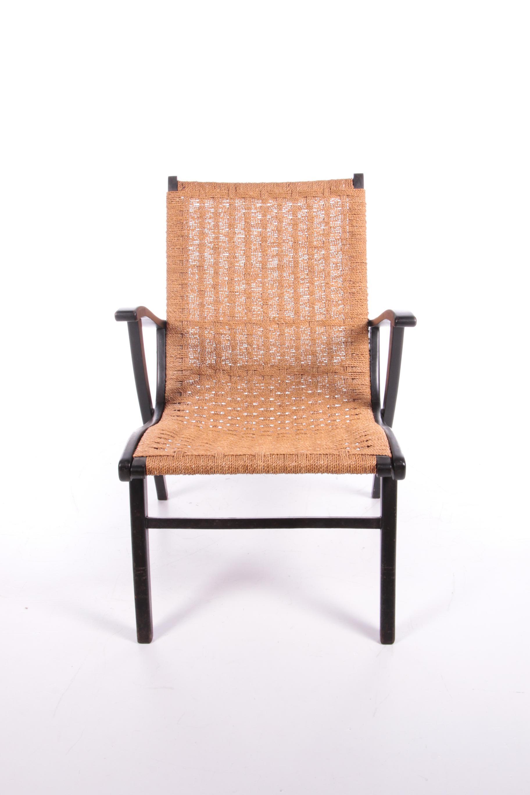 Vintage armchair with braided rope for Vroom & Dreesman from ca. 1957.

This armchair is somewhat reminiscent of Bas van Pelt's furniture (wood with rope). The frame is made of beech wood and sprayed black and the seat of braided
