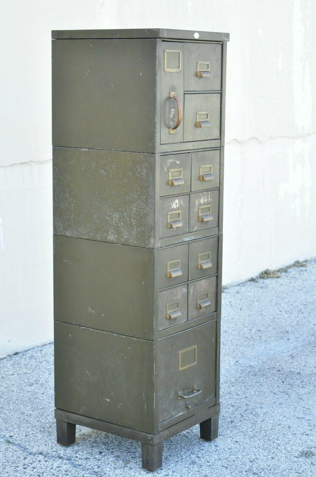 Vintage army green steel metal industrial narrow stacking file cabinet by Art Metal. Item features steel metal construction, 4 stacking file sections, original army green distressed finished, original label, 12 drawers, solid brass hardware, very