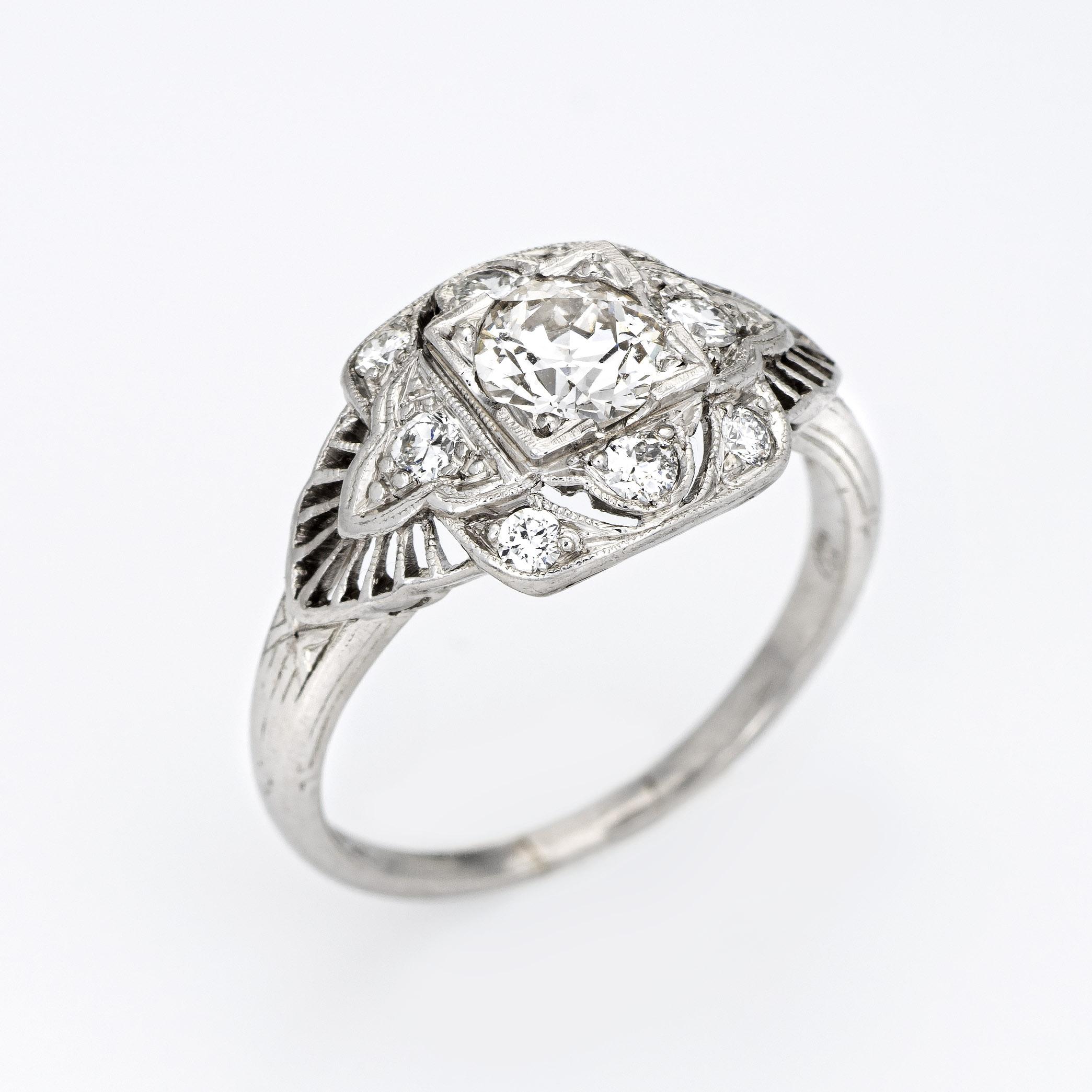 Finely detailed vintage Art Deco era diamond engagement ring (circa 1920s to 1930s) crafted in 900 platinum. 

Centrally mounted 0.57 carat old European cut diamond (L color and SI1 clarity). The mount is accented with a further 0.44 carats of
