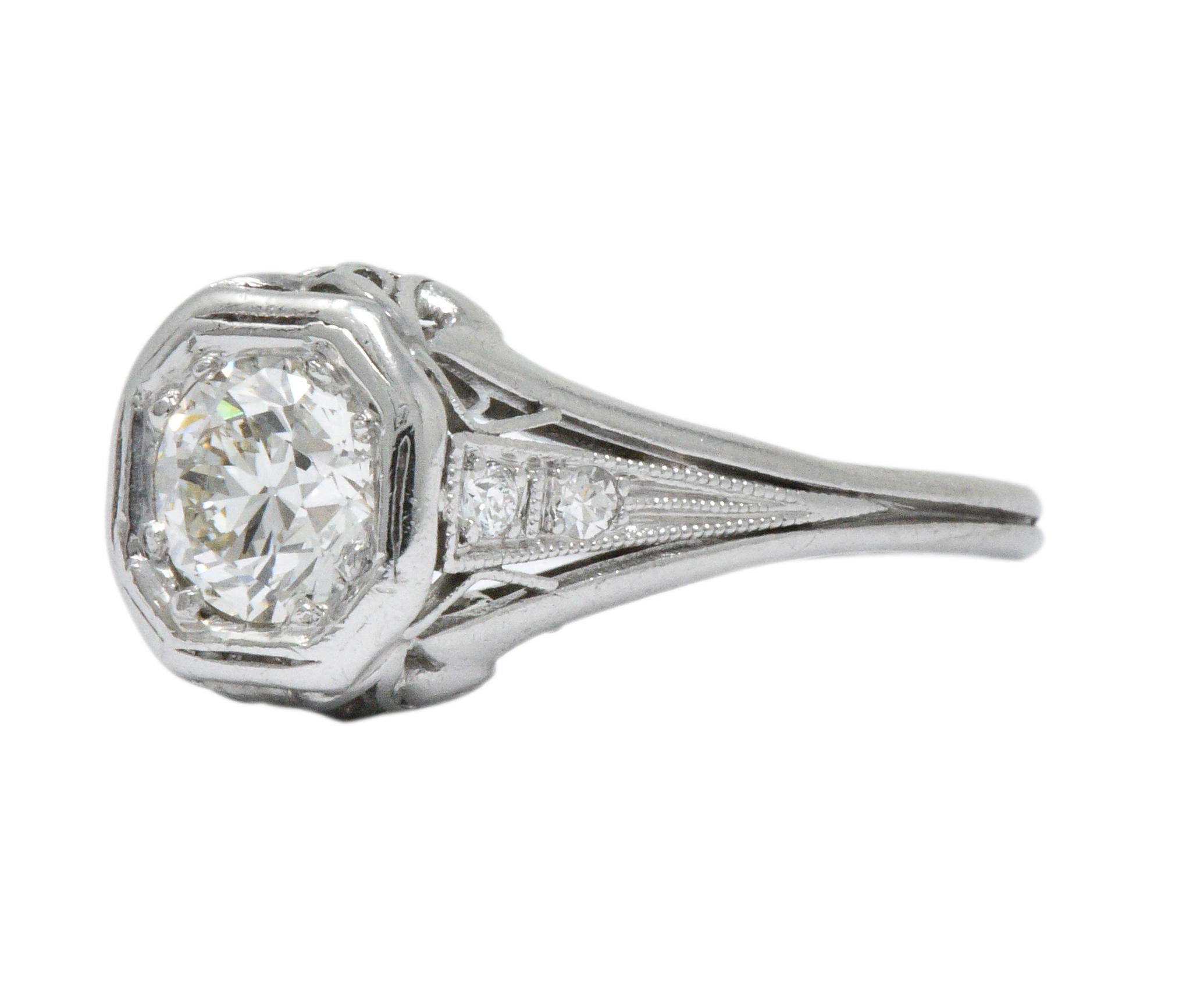 Centering an old European cut diamond weighing 0.68 carats total, J color and VS clarity

Flanked by four round cut diamonds, weighing approximately 0.05 carats total, eye-clean and white

Geometric head with delicately pierced foliate