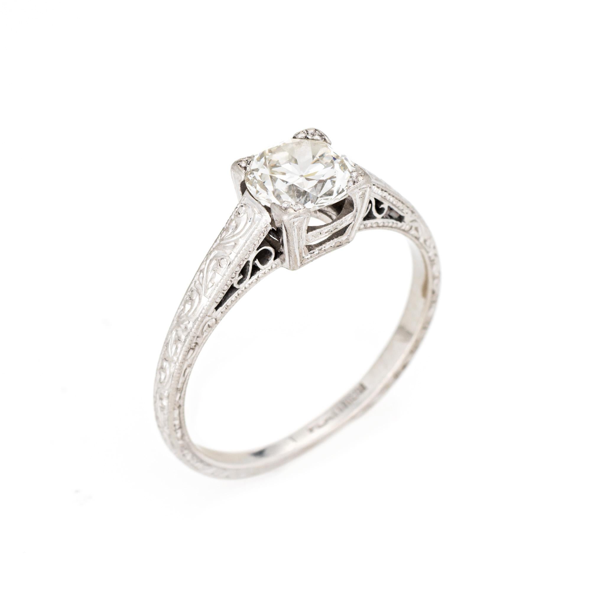 Finely detailed vintage Art Deco diamond ring (circa 1920s to 1930s) crafted in 900 platinum. 

Center set old European cut diamond is estimated at 0.89 carats (estimated at I-J color and SI1 clarity).   

The stylish Art Deco era ring features a