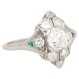 Original Art Deco vintage Old-Euro cut natural diamond ring. Handmade in a platinum setting into a stunning V-shaped motif that sits beautifully on the finger. Centering a 0.63-carat center stone and symmetrically patterned diamond and emerald