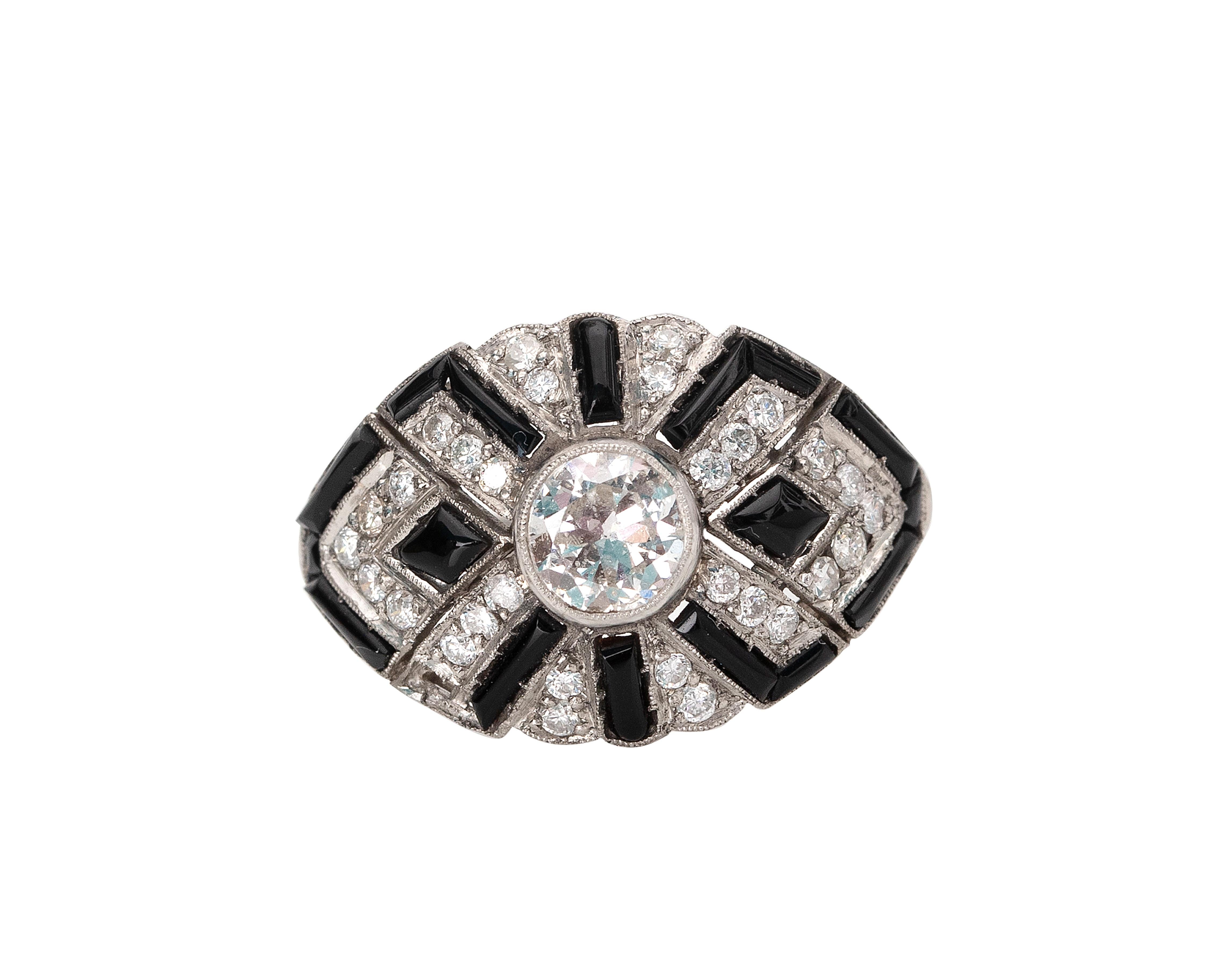 Here we have a excellent example of an Art Deco era  ring! This genuine 1920's ring features a brilliant .81 Carat Old European cut diamond bezel set in a highly detailed platinum ring. The ring utilizes black onyx for an extremely cool geometric