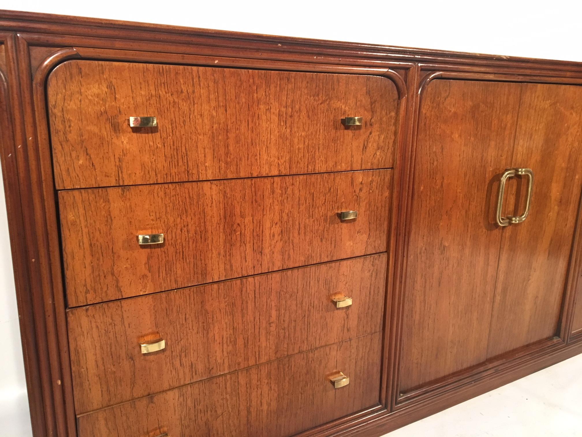 Vintage 12-drawer dresser by Century Furniture features art deco style detailing and brass hardware. Extremely heavy, solid construction. Good vintage condition with small abrasions to top surface (see photos).