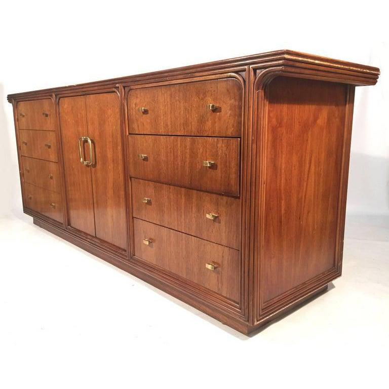 Vintage 12-drawer dresser by Century Furniture Company features art deco style detailing and brass hardware. Heavy, solid construction. Good vintage condition with abrasions and scuffs (see photos).
 