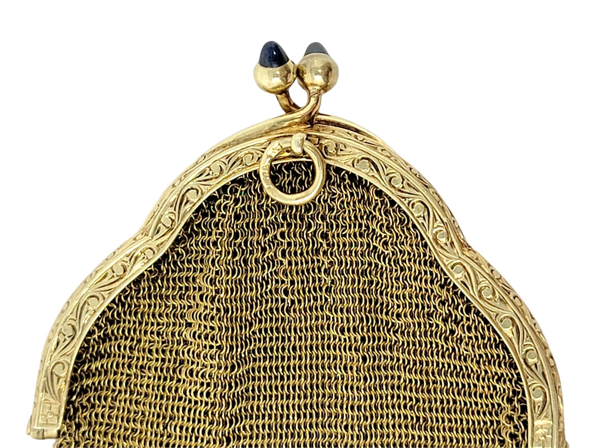 Exquisite 14 karat yellow gold flapper purse. This gorgeous and unique Art Deco piece is composed of delicate woven 14 karat yellow gold mesh accented by 2 grayish-blue sapphire cabochons at the kiss lock clasp. Note this is a small coin purse size.