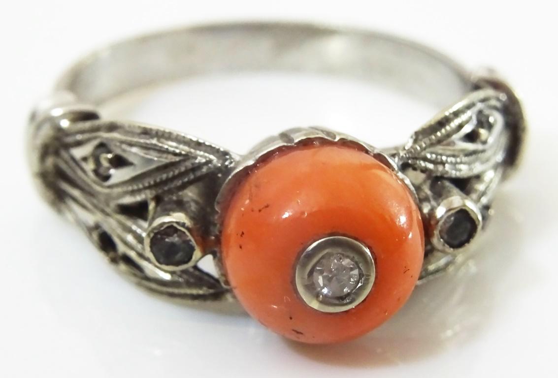 A lovely delicate example of the Art Deco style in Rings.
Made in acid checked 18 karat Gold.
The Centre of the Ring is 10 mm Coral Bead set with 2 point diamond in the centre of the bead.
There are a further 2 Diamonds on the shoulders of the