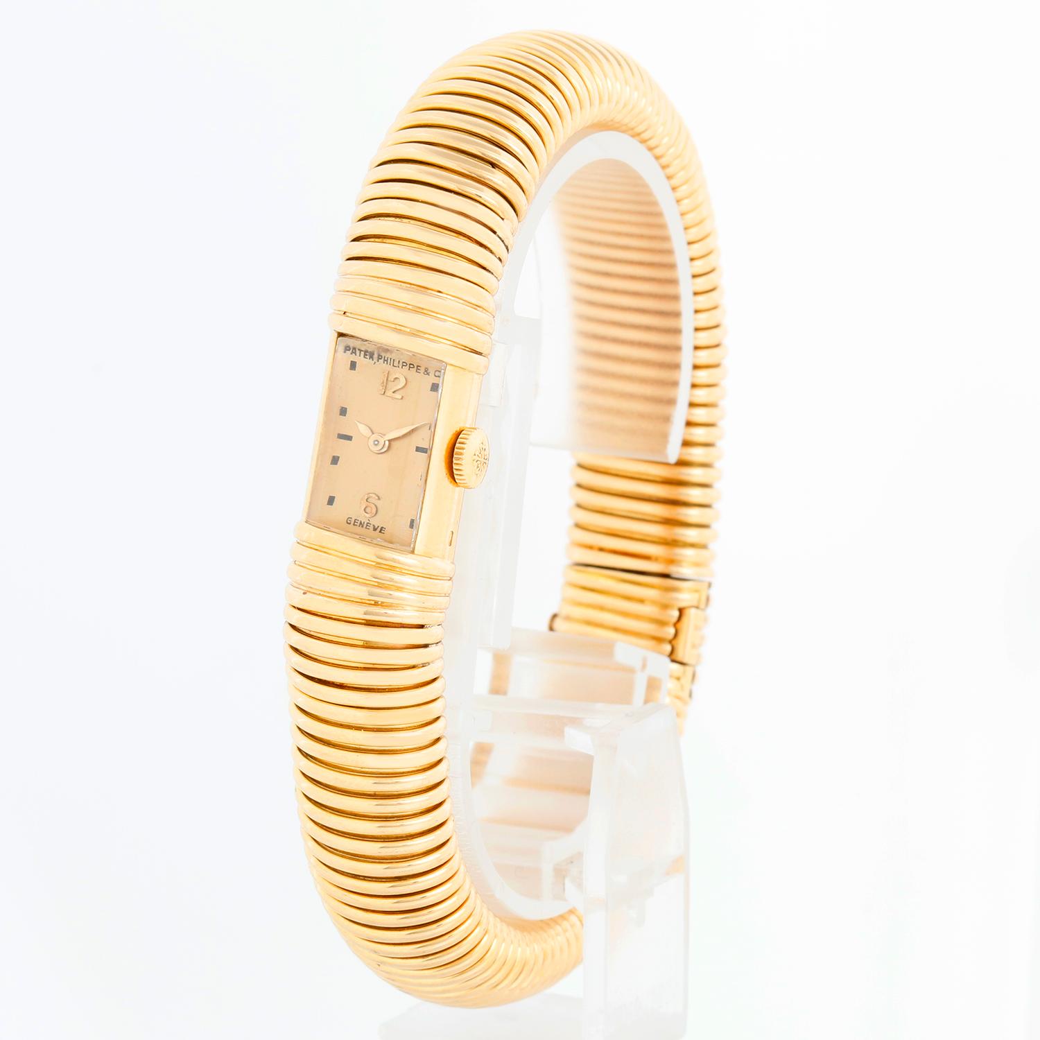 Vintage Art Deco 18K Yellow Gold Patek Philippe Watch - Manual winding. 18K Yellow Gold rectangular Art Deco case ; inscription on case back ( 14 x 13 mm ). Champagne dial with hour markers. 18K Yellow gold bracelet. Will fit a 7 inch wrist.
