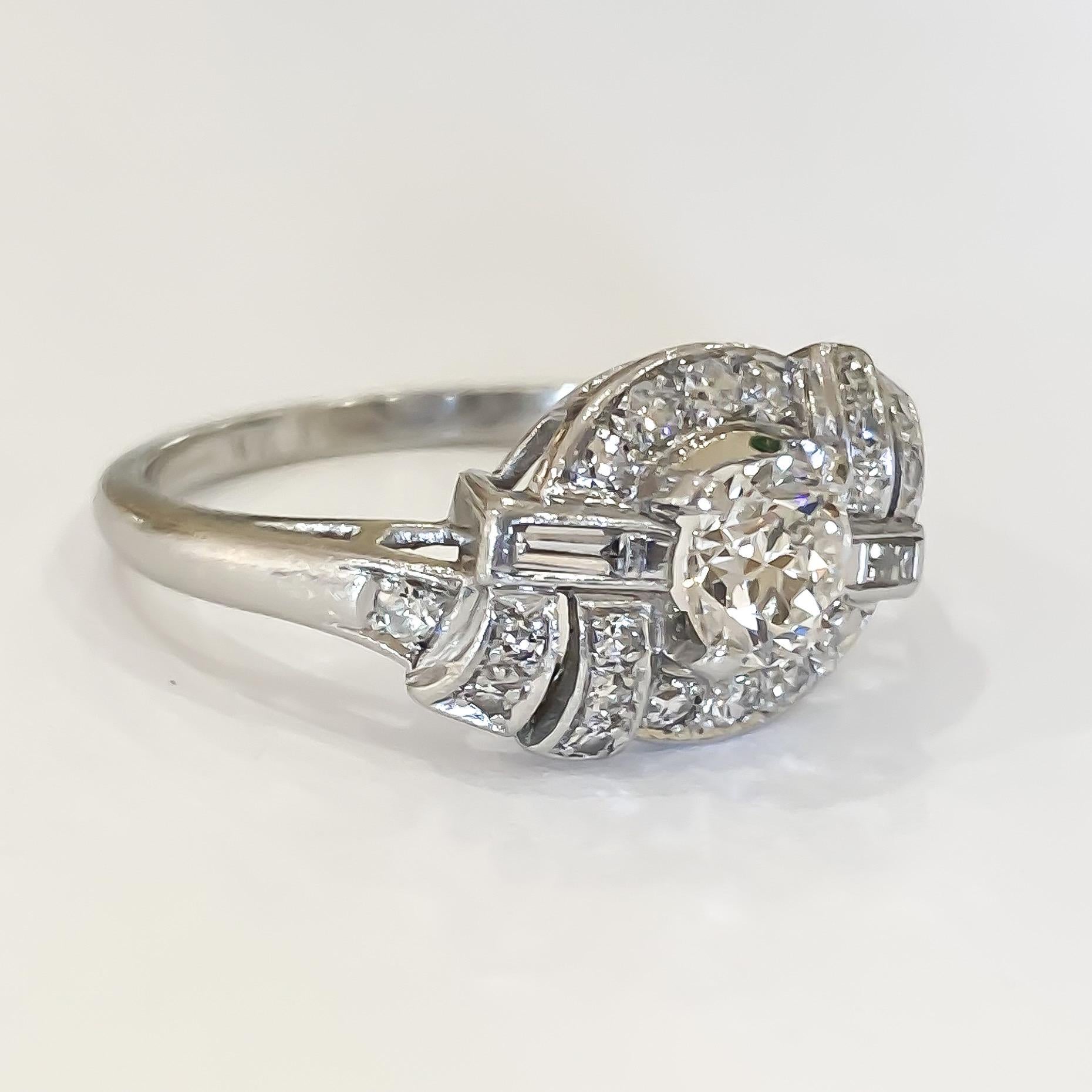 Authentic vintage Art Deco diamond ring designed in Platinum and set with old European, single and baguette cut diamonds. The center is set in four prongs flanked by pave set diamonds in an offset ribbon mounting. The baguette diamonds are bezel set