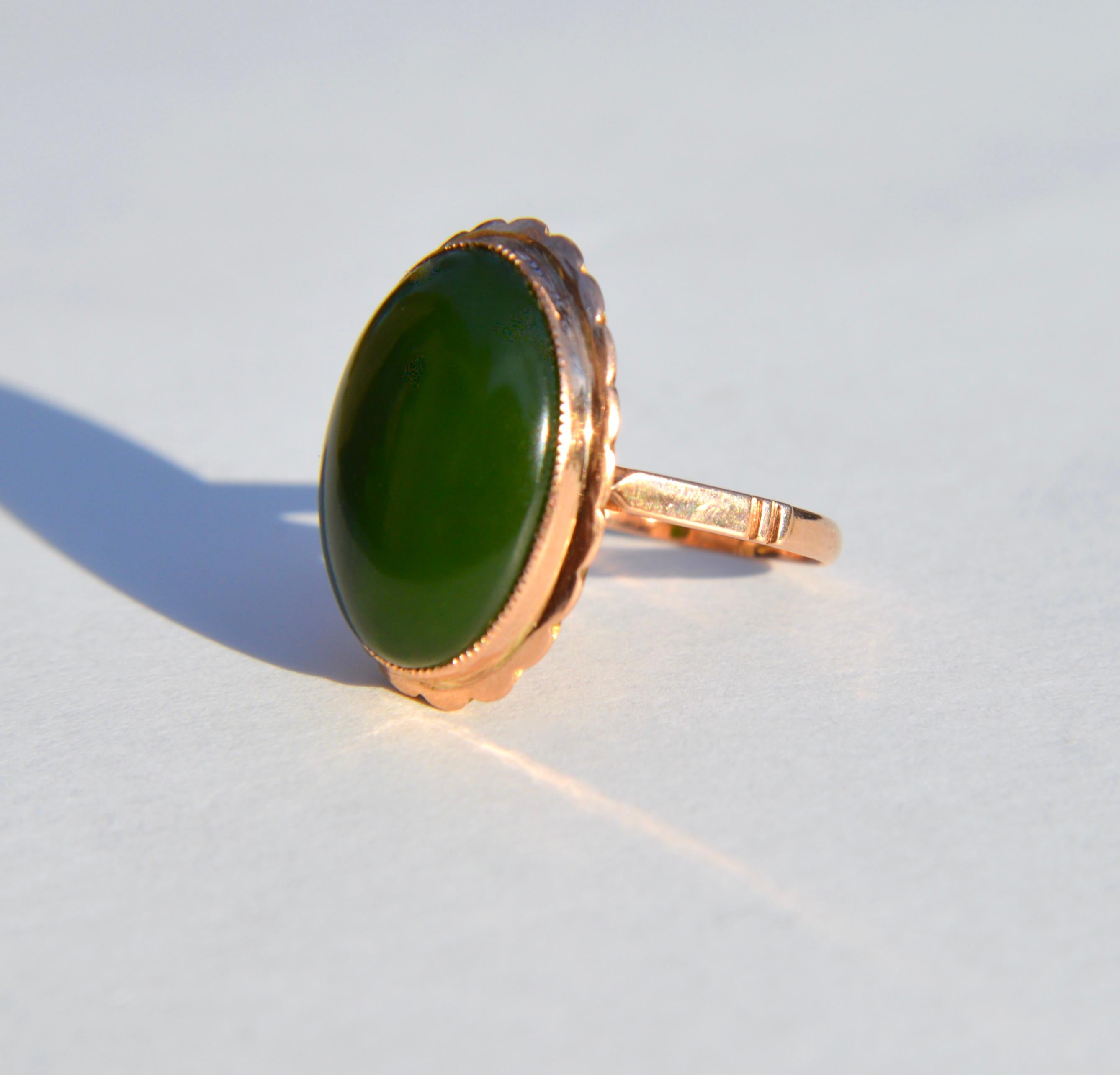 Gorgeous antique vintage Art Deco era circa 1930s nephrite jade 12.86 carat oval cabochon cocktail ring in 14K rose gold. Size 6, can be resized by a jeweler. In very good condition. no visible wear to the stone. Jade stone is a beautiful deep