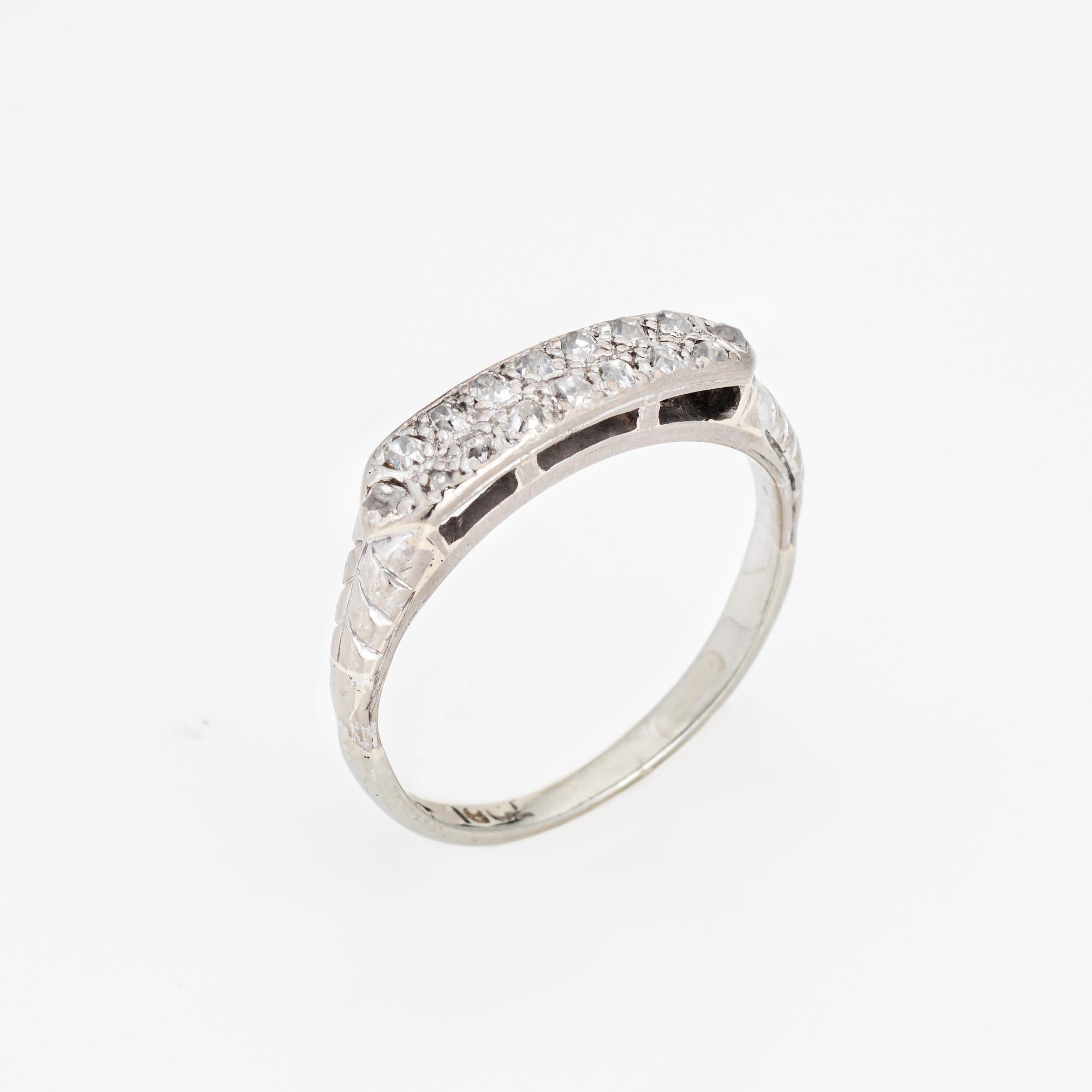 Finely detailed vintage Art Deco diamond wedding band (circa 1920s to 1930s) crafted in 14 karat white gold. 

16 single old cut diamonds total an estimated 0.16 carats (estimated at I-J color and SI1-I1 clarity).   

The elegant wedding band