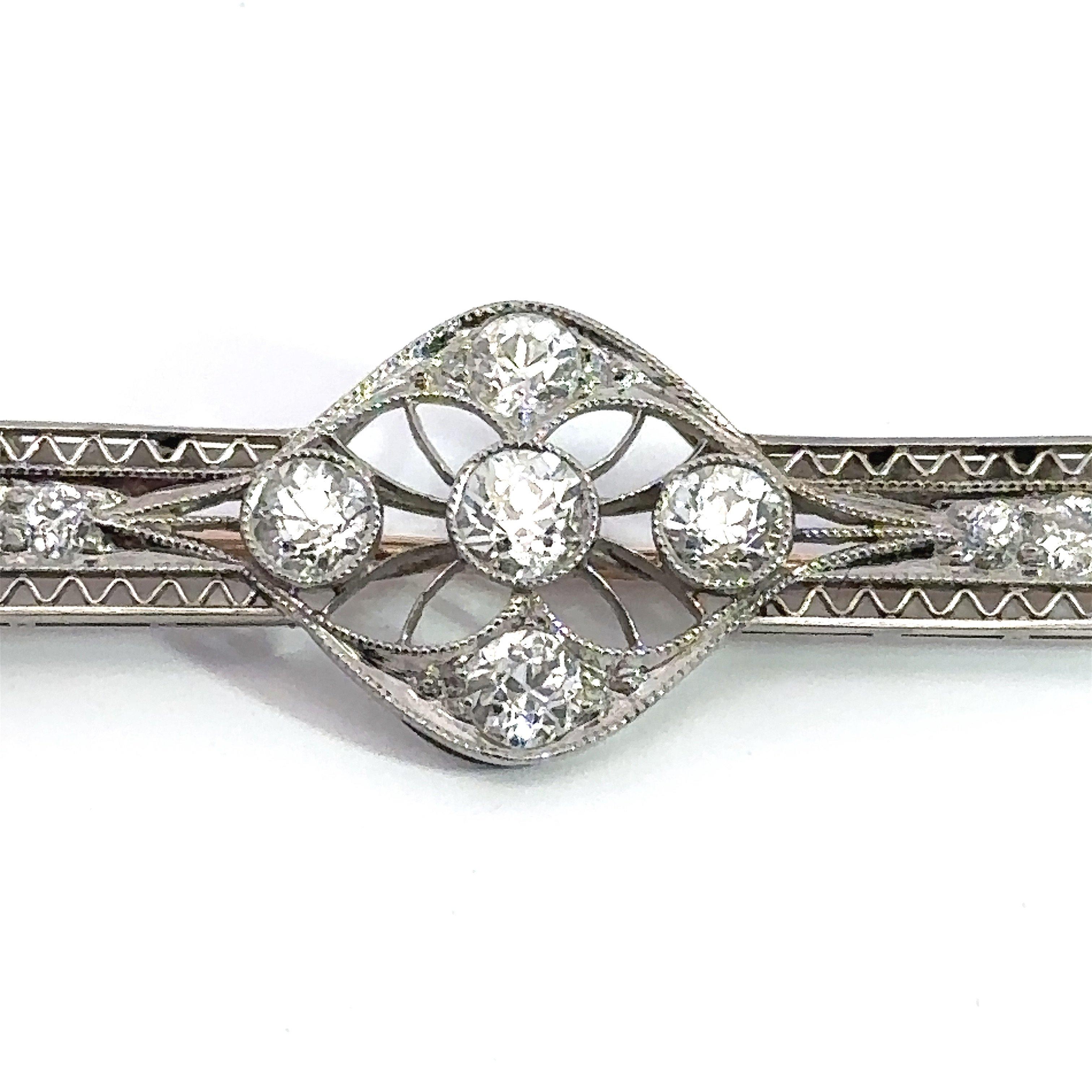 This Art Deco 1920’s-era brooch pin is crafted in platinum with 10KT yellow gold stick pin. The pin contains 2CT old-mine cut and old-European cut diamonds, F-H Color, VS-SI Clarity. The pin measures 3