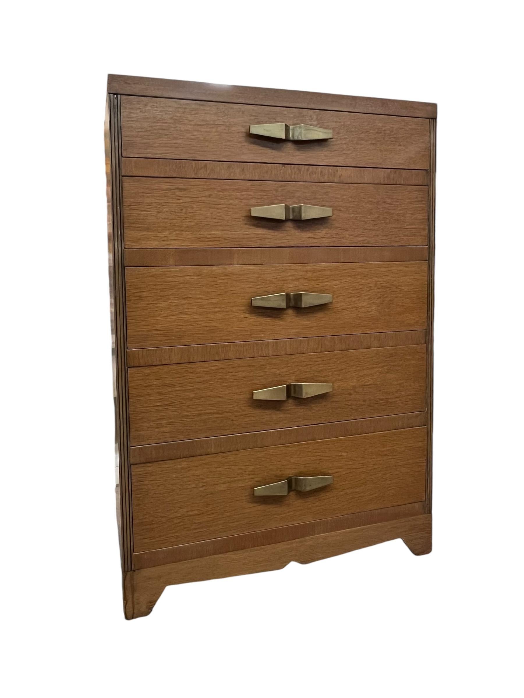 Art Deco highboy dresser chest of drawers  in style of Robsjohn Gibbings for Widdicomb. This early representation is at the turning point between machine age and modern. The mahogany finish has aged to a rich honey color. Sleek and stately with just