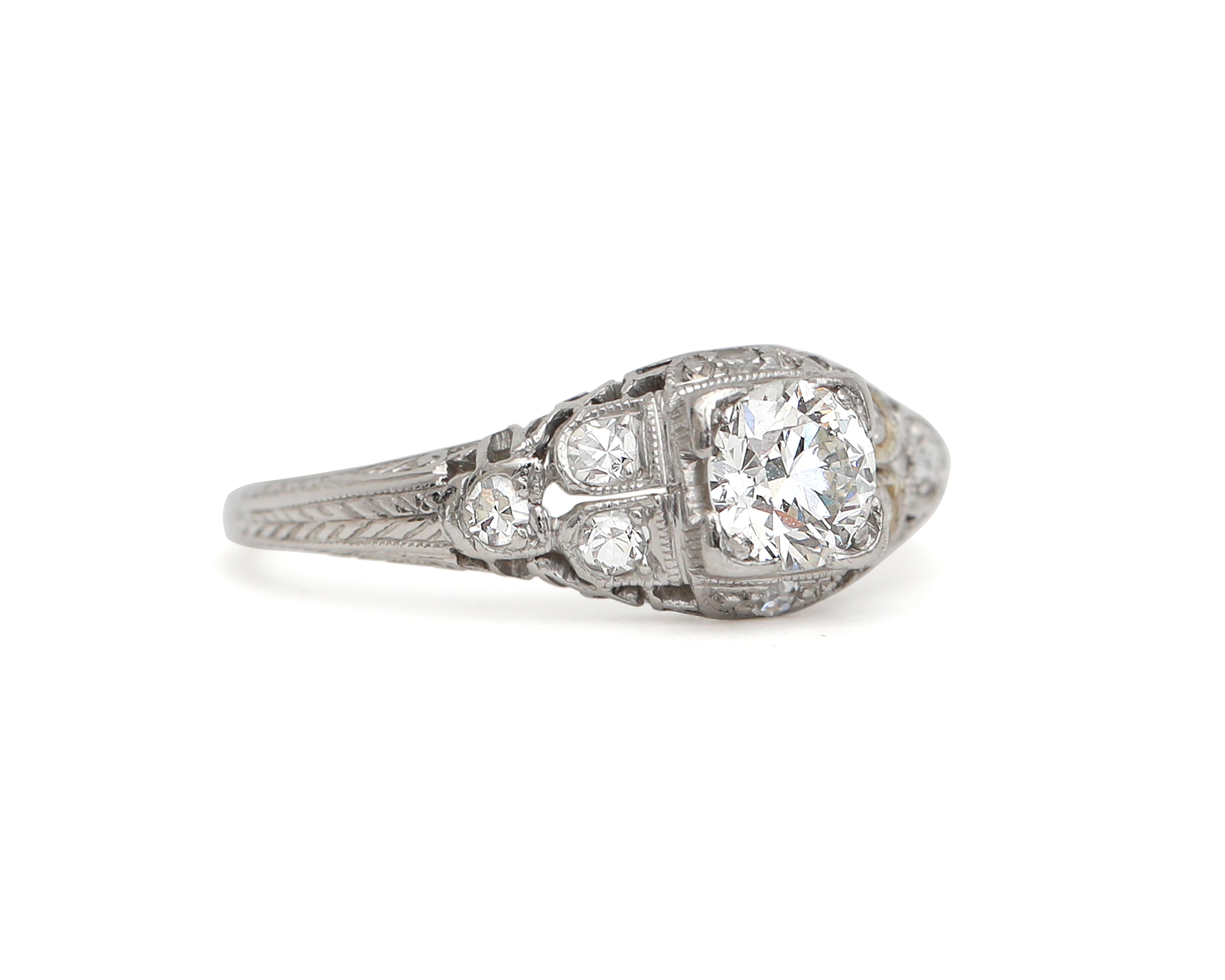 This fine example of Art Deco style is crafted in platinum with smaller diamond accents highlighting the stunning solitaire. The brilliant center diamond is approximately 0.5 carats and the accent diamonds are .6 carats. This combination is very