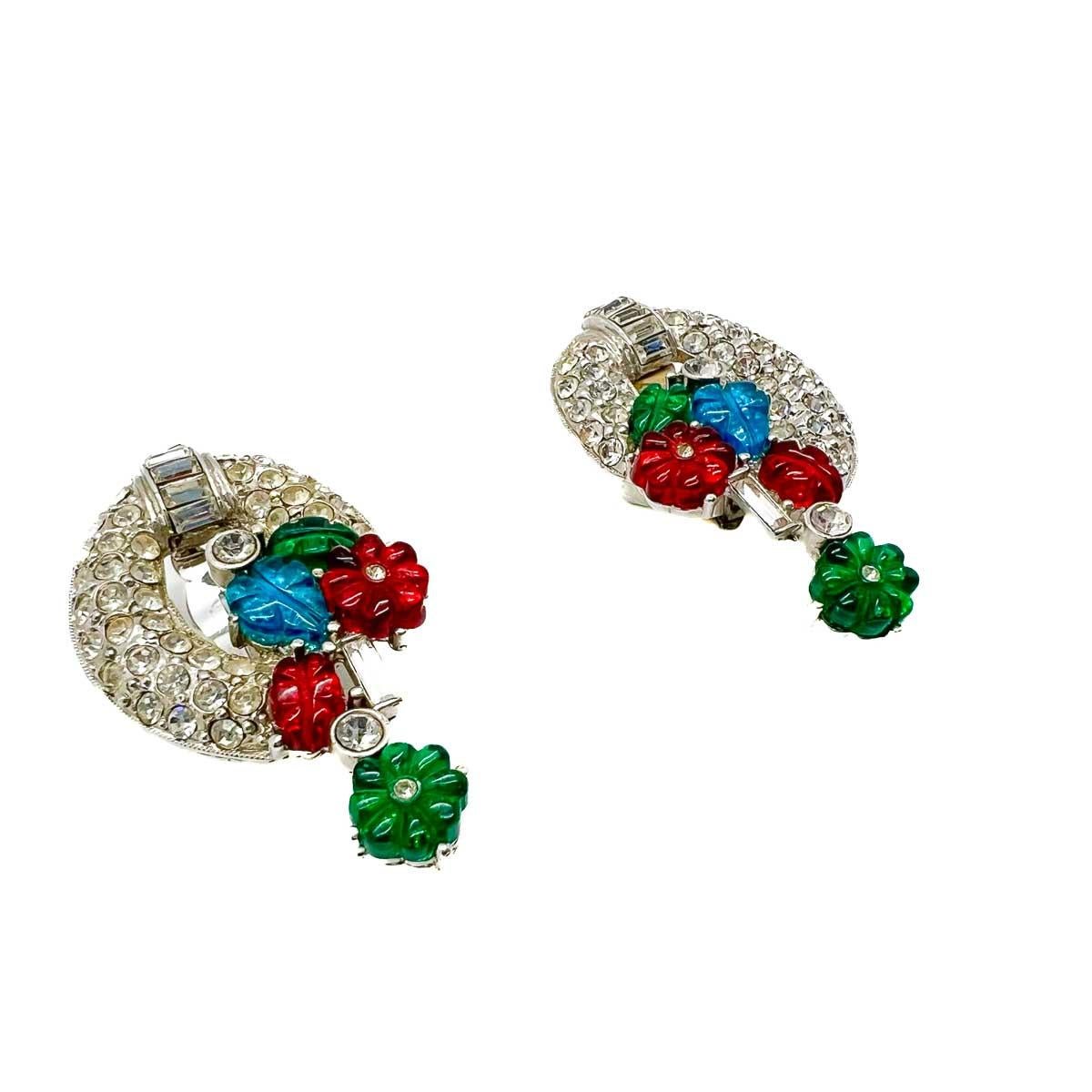 A fabulous pair of Vintage Art Deco '89 Tutti Frutti Earrings. A timeless Art Deco design is smothered in an array of pave set crystals and Tutti Frutti style glass motifs in gem colours. A rare and glamorous find.
An unsigned beauty. A rare