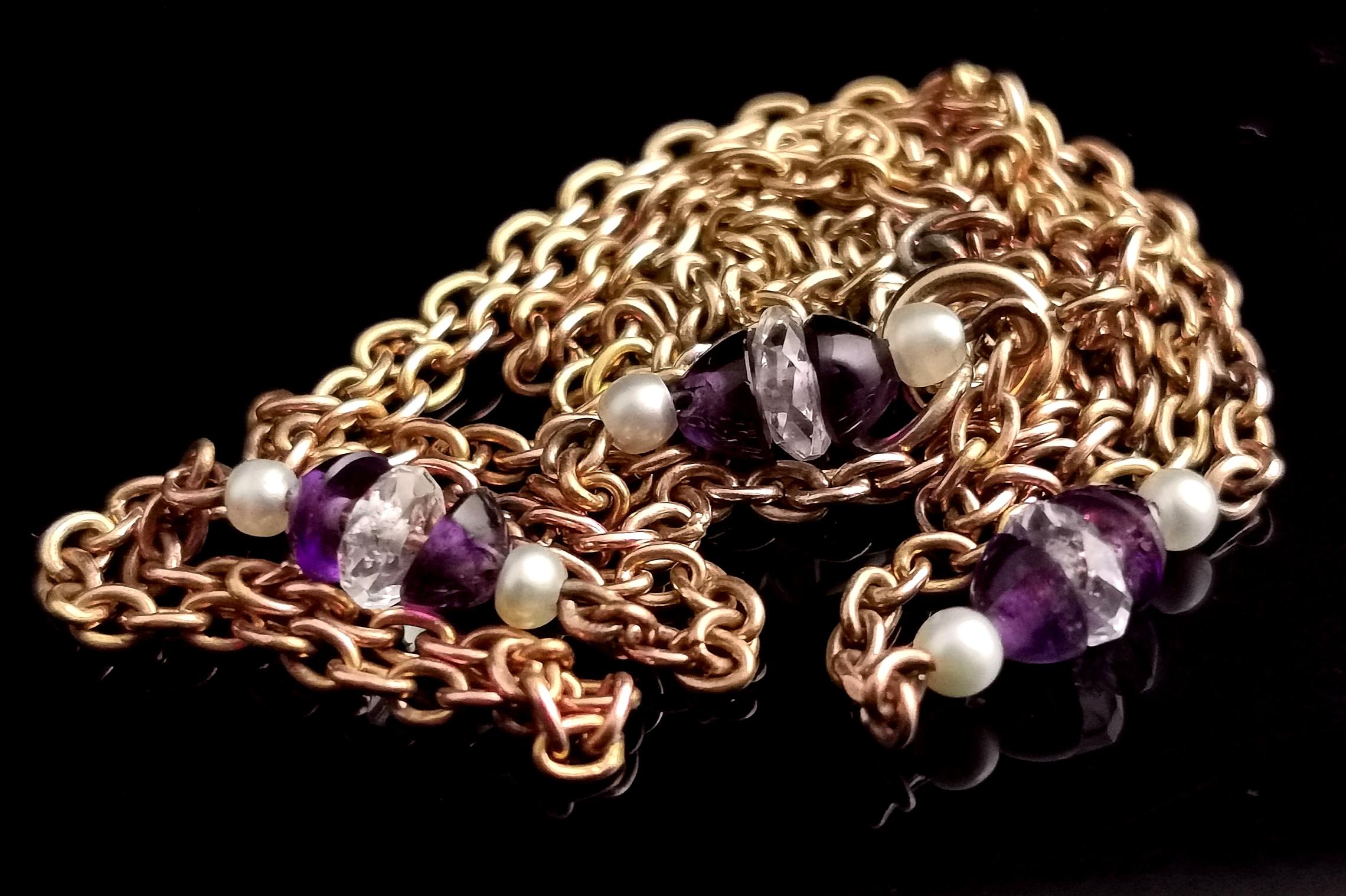 A beautiful vintage Art Deco 9kt yellow gold, Amethyst, seed pearl and rock crystal necklace.

The necklace features a fine rich 9kt gold chain link with three beaded spacer bars.

Each gold bar is adorned with a faceted rock crystal bead sandwiched