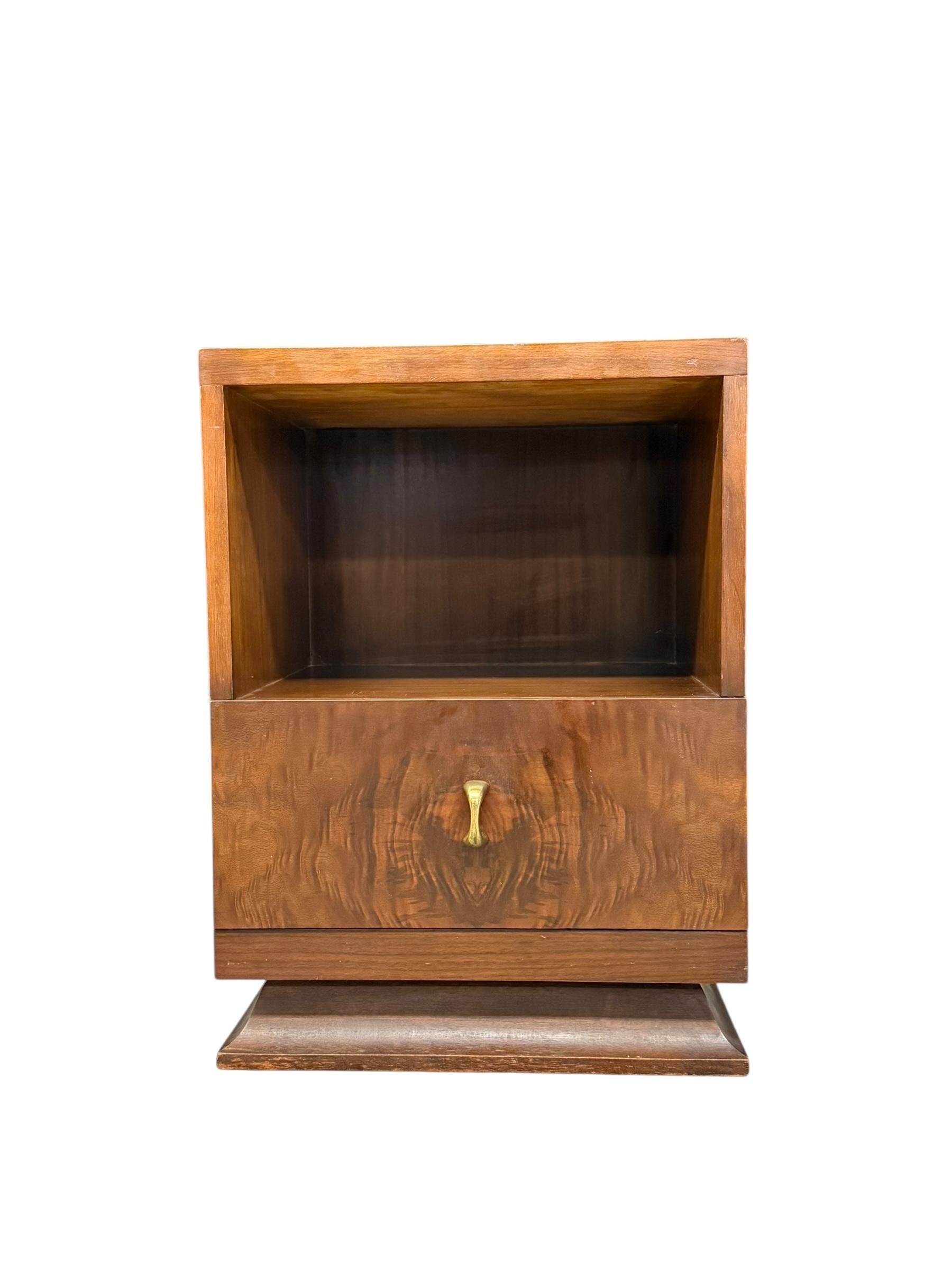This vintage Art Deco table, likely from the 1930s-1950s, exemplifies the era’s signature style with its sleek, geometric design and luxurious materials. Crafted from richly grained wood—possibly walnut—with a polished, medium-brown finish, the