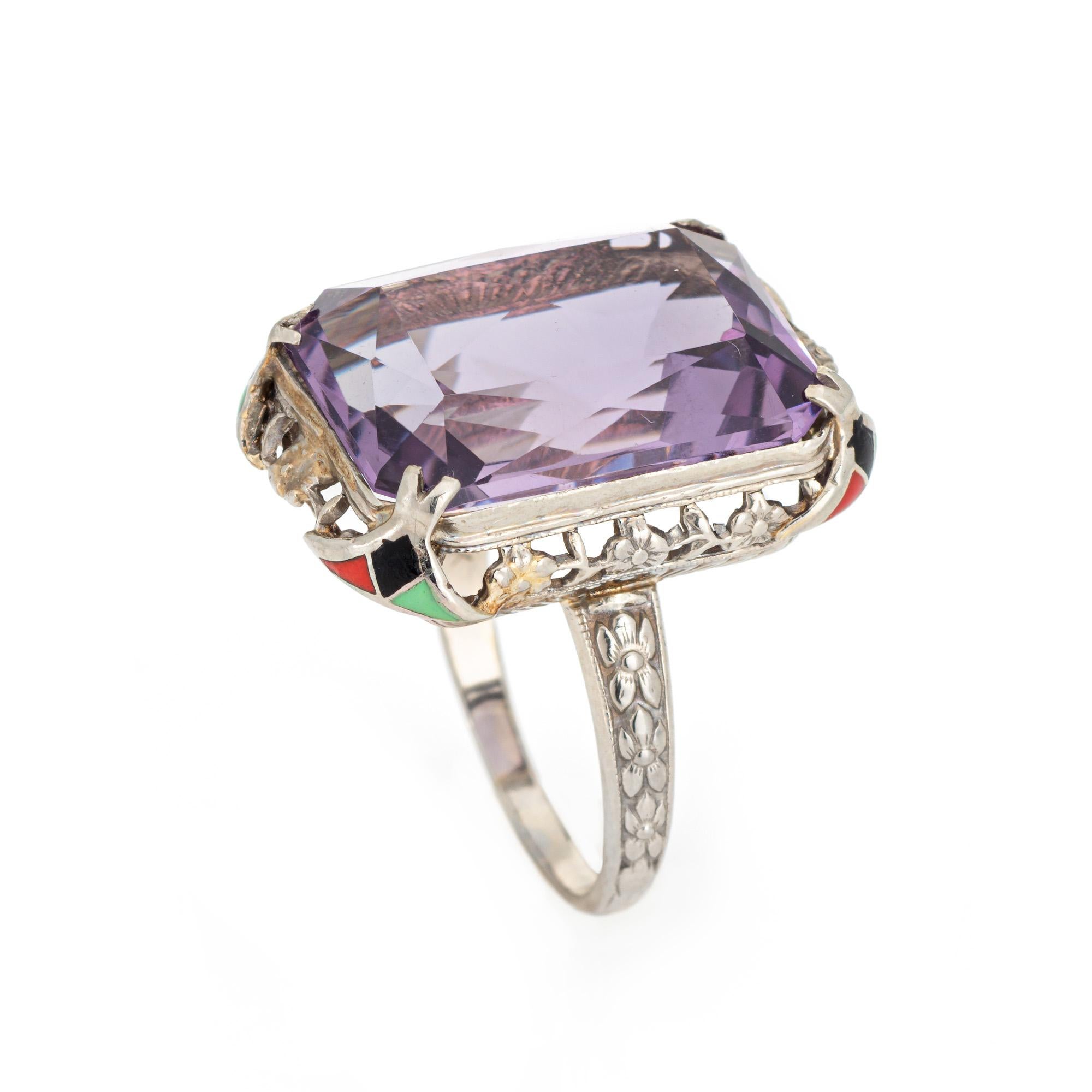 Vintage Art Deco era amethyst & enamel cocktail ring (circa 1920s to 1930s) crafted in 14 karat white gold.

Faceted square cut amethyst measures 18mm x 13mm. Black, green and red enamel adorns each end of the mount, adding a pop of color to the