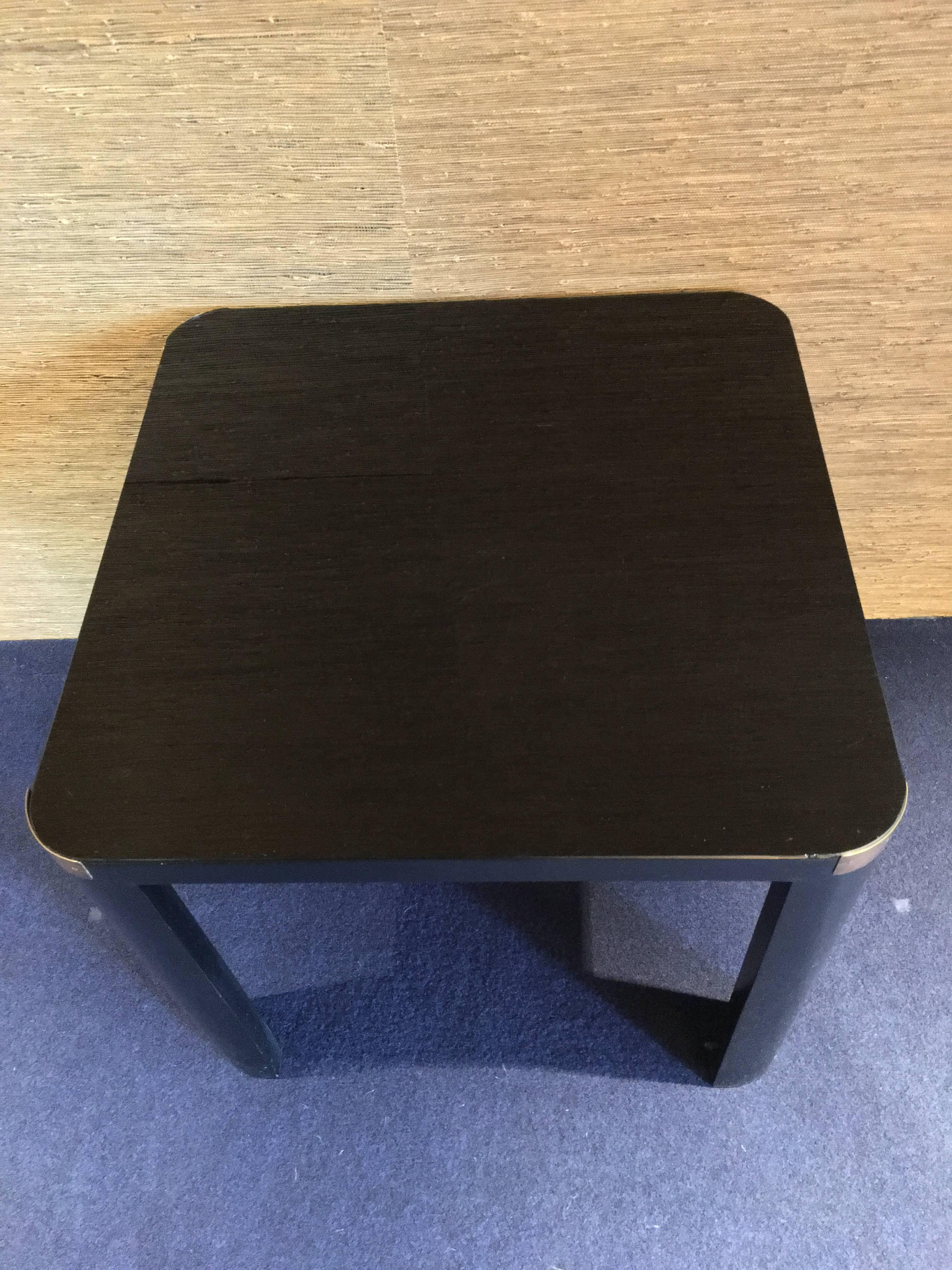 Vintage table coffee, made in Italy. Art Deco period. Black wooden structure, black glass top, brass details and white ceramic for the little shelves.