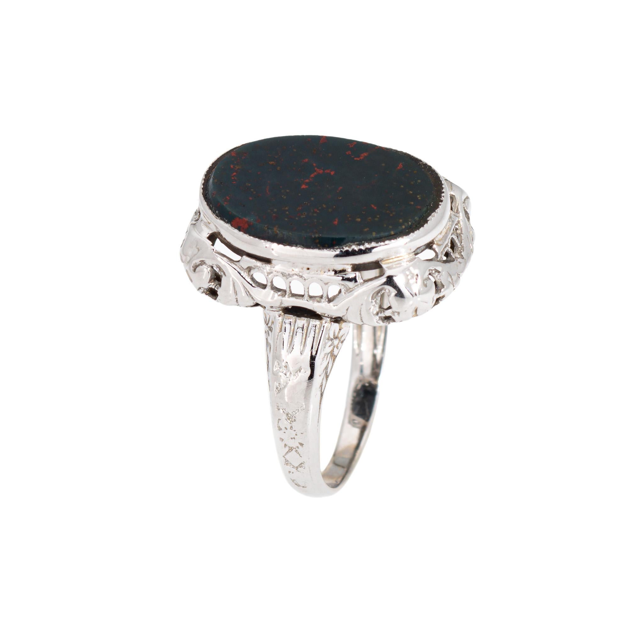 Stylish and finely detailed Art Deco bloodstone ring crafted in 14 karat white gold (circa 1920s to 1930s).

Bloodstone measures 13.5mm x 10mm. The bloodstone is in very good condition and free of cracks or chips.

The rich dark green teal