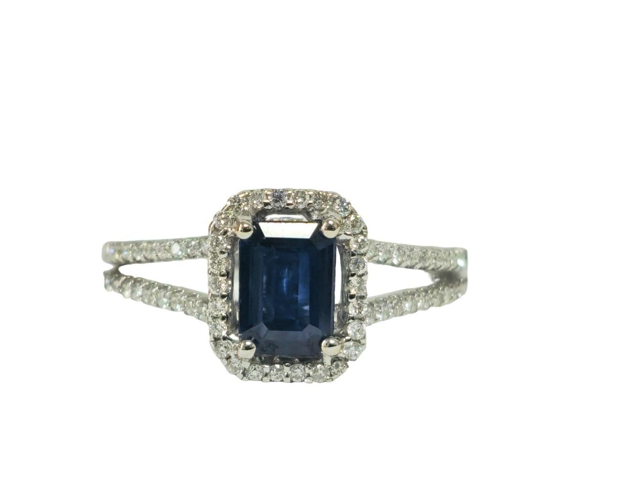 Indulge in sophistication with our Vintage Art Deco Style Blue Sapphire and Diamond Ring, crafted from luxurious 18k white gold. Featuring a stunning 1.00 carat blue sapphire, emerald cut and set in prongs, alongside 1.00 carat of dazzling round
