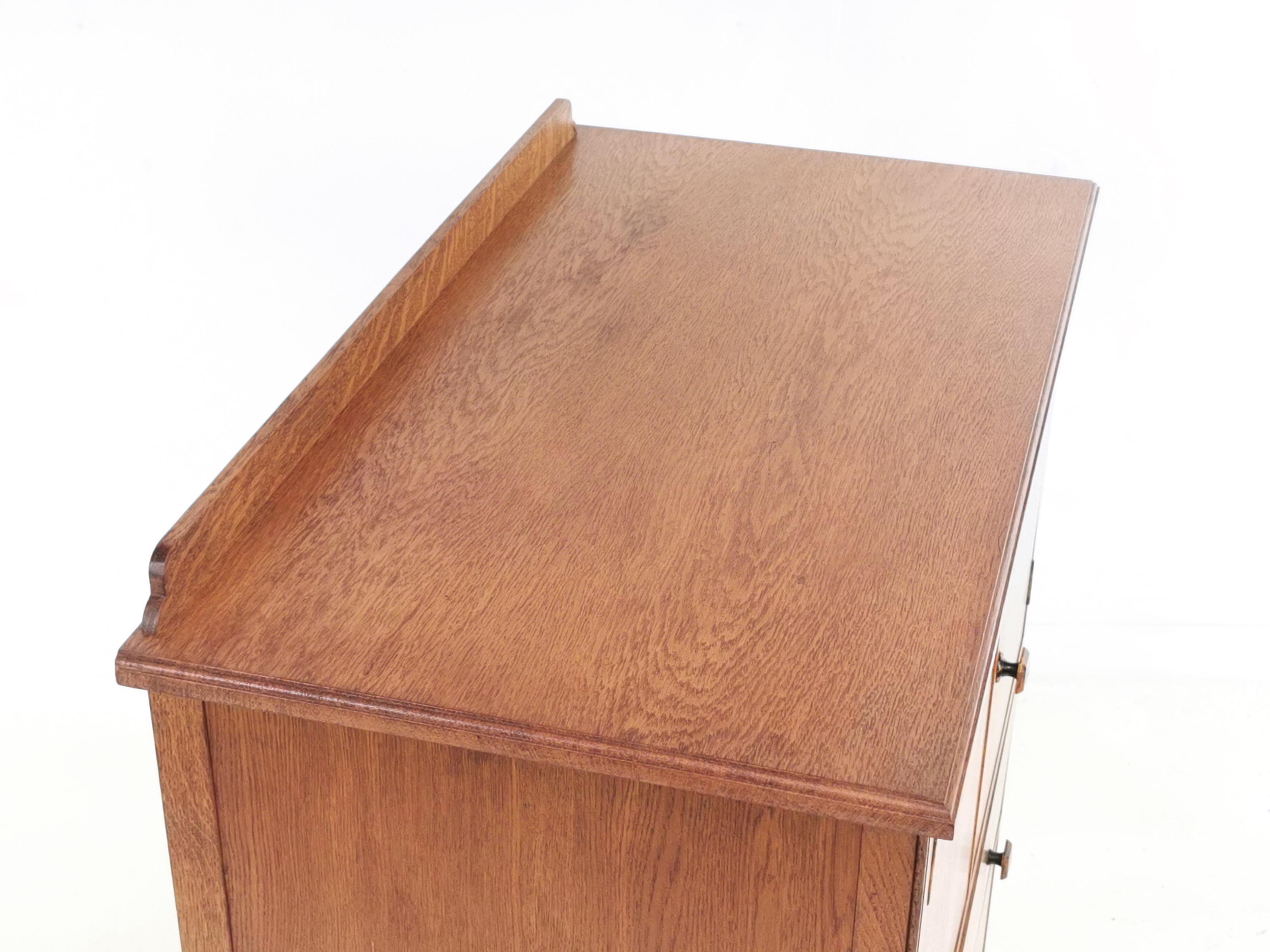 Maple & Co Tall boy

British made Maple & Co, tallboy compactum chest of drawers on out-turned legs. Featuring square bevelled stone pull handles and art deco motif on top of the cupboard doors.

From the first quarter of the 20th century, this
