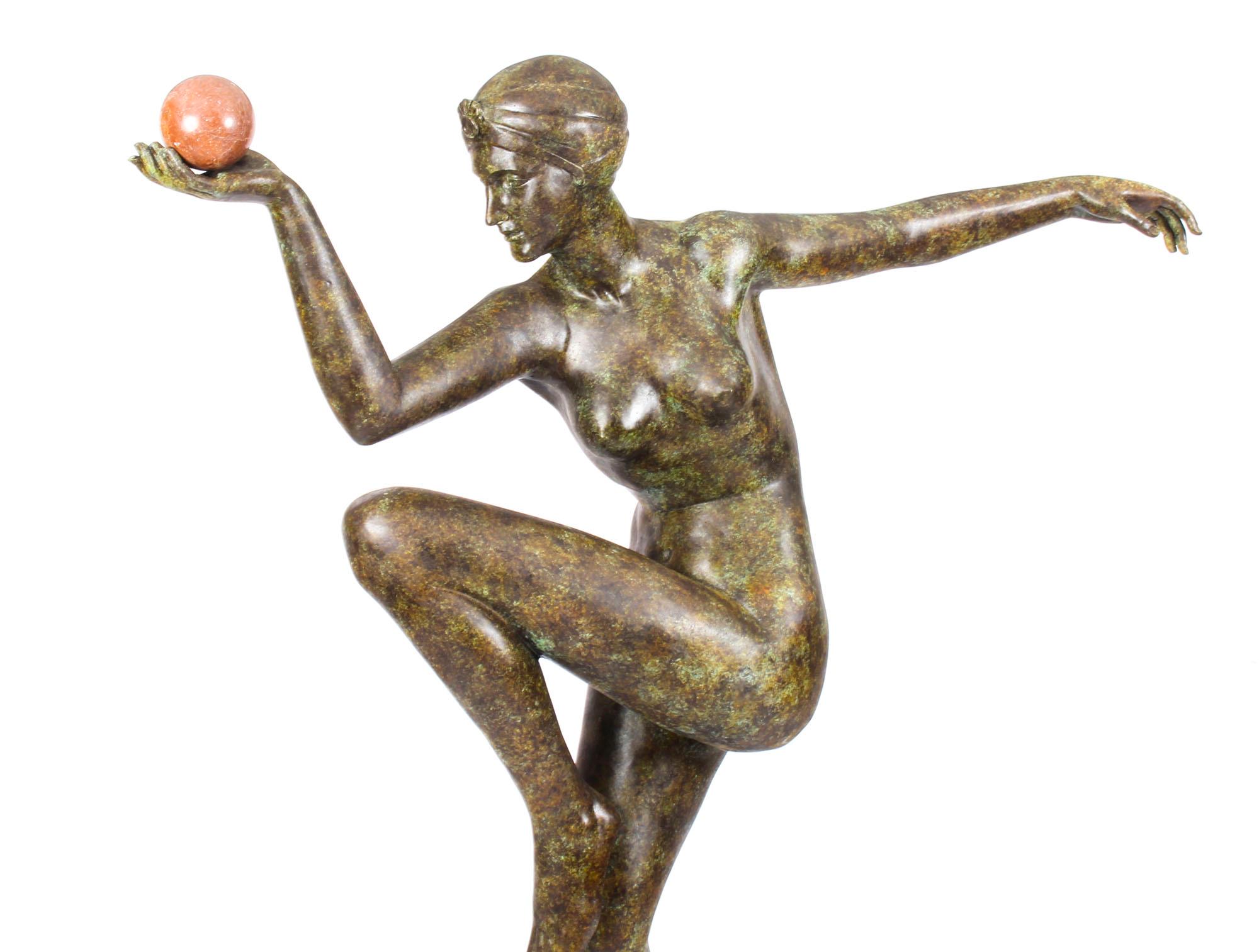 This is a stylish and high-quality solid bronze sculpture in the form of a sophisticated dancing lady with a ball, in the Art Deco manner and dating from the last quarter of the 20th century.

This striking bronze features an attractive nude lady