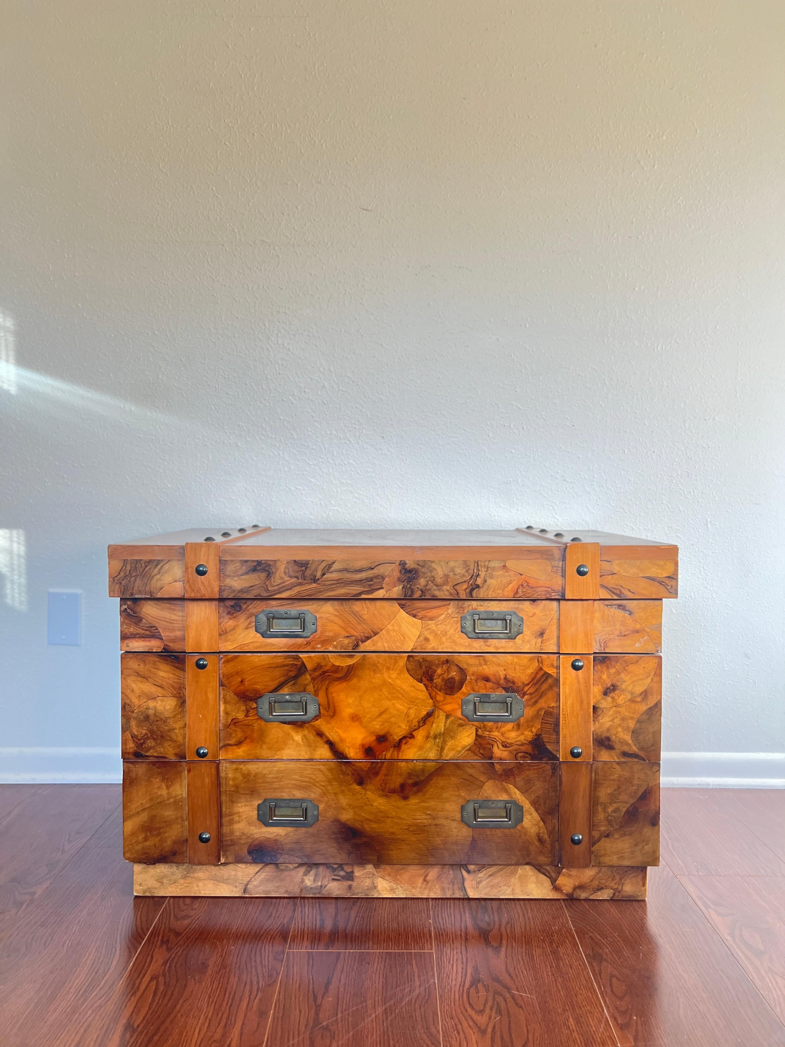 A beautiful vintage burl chest including 2 drawers with recessed pulls and storage space on top. This chest features rich burl throughout, with recessed campaign style hardware. This unique chest can be a side table or even a coffee table. Stamped
