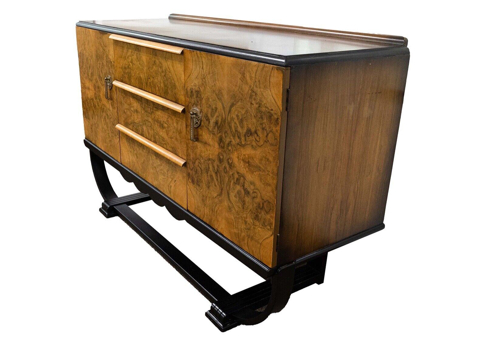 We presents this beautiful sculpted burlwood buffet or credenza or can be used for a bar. Ebonized wood curved base with bronze handles. In good vintage condition. Dimensions: 54