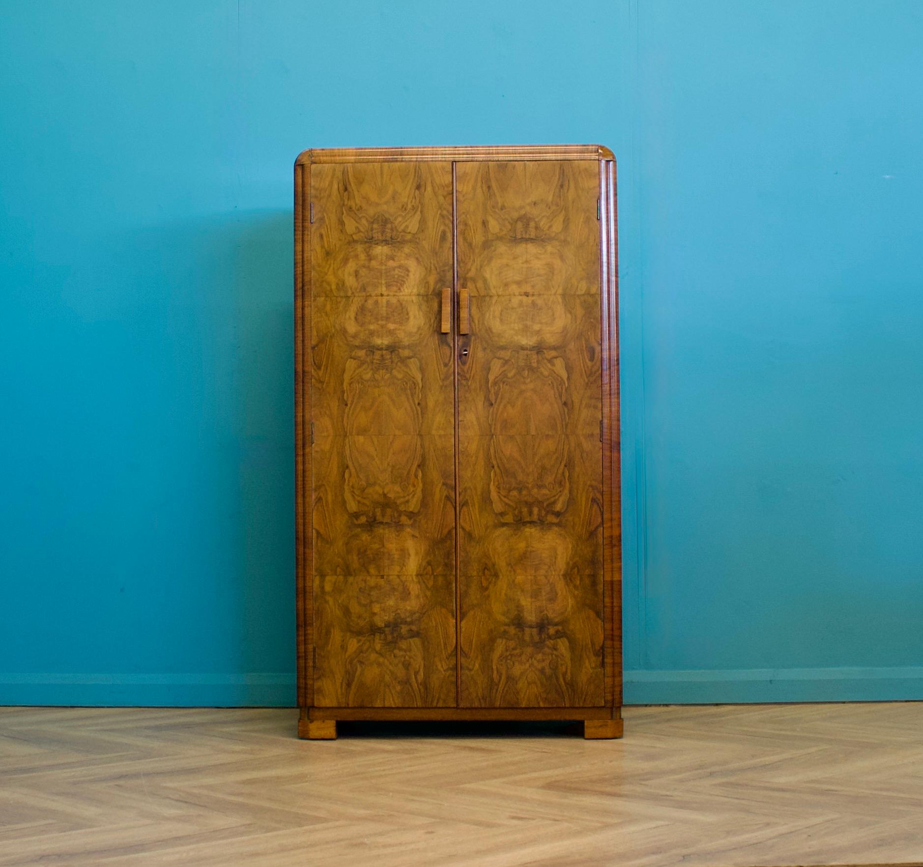 An Art Deco 1930's burr walnut compact wardrobe
Featuring a pull out rail and shelves