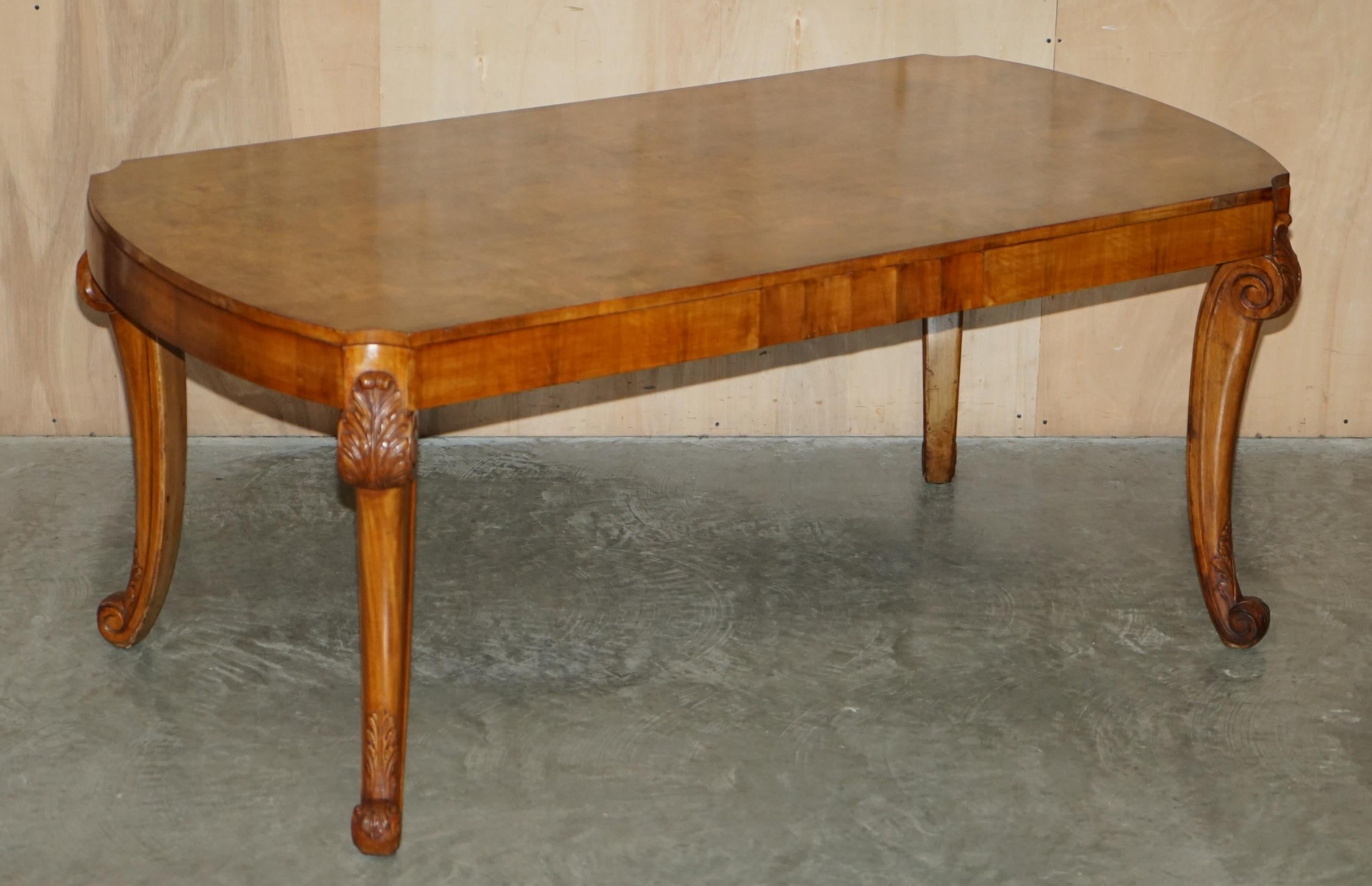 We are delighted to offer for sale this exquisite heavily carved Art Deco Burr Walnut dining table with six sculptural dining chairs

A beautiful example of this kind of work, the cuts of walnut are truly sublime, the table leg carving is second
