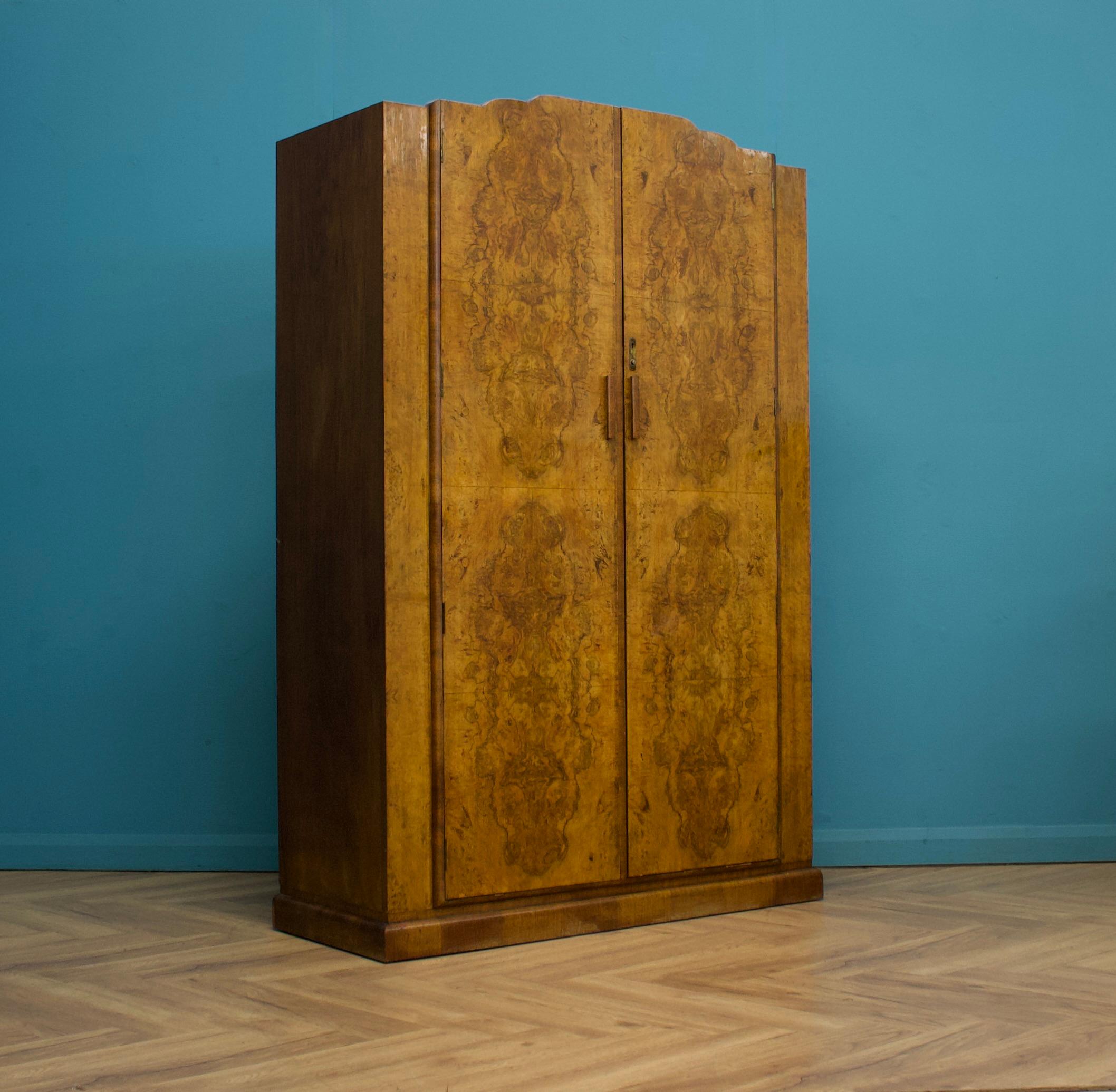 An Art Deco walnut wardrobe - circa 1930's -
Fitted out with two pull out clothes rails, coat hooks and a shelf

Featuring decorative metal latch
The wardrobe separates into two halves