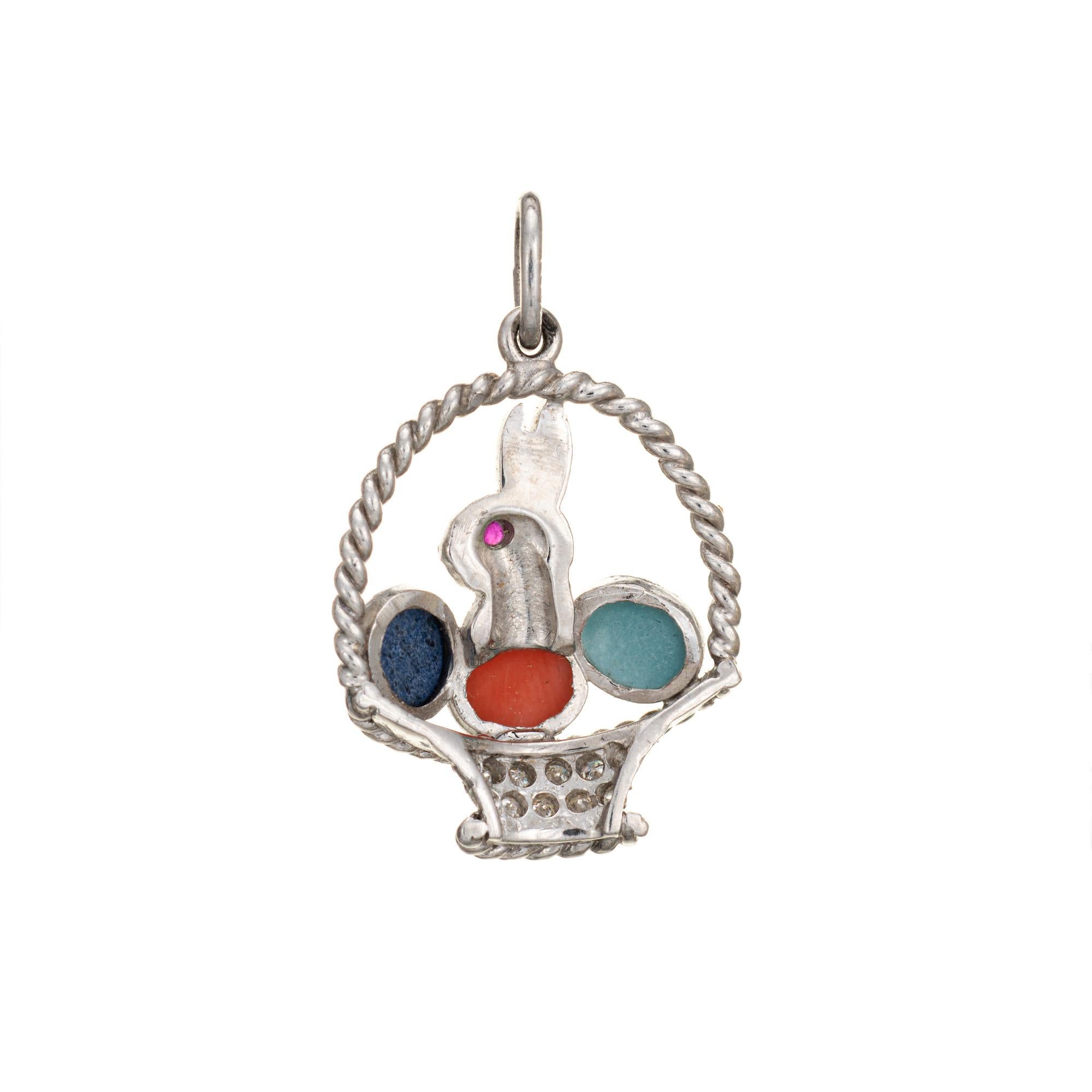 Finely detailed vintage Art Deco era charm crafted in 900 platinum (circa 1920s to 1930s).  

Lapis, coral and turquoise are set into the charm (4mm x 3mm). One estimated 0.01 carat ruby is set into the eye. 11 diamonds total an estimated 0.05
