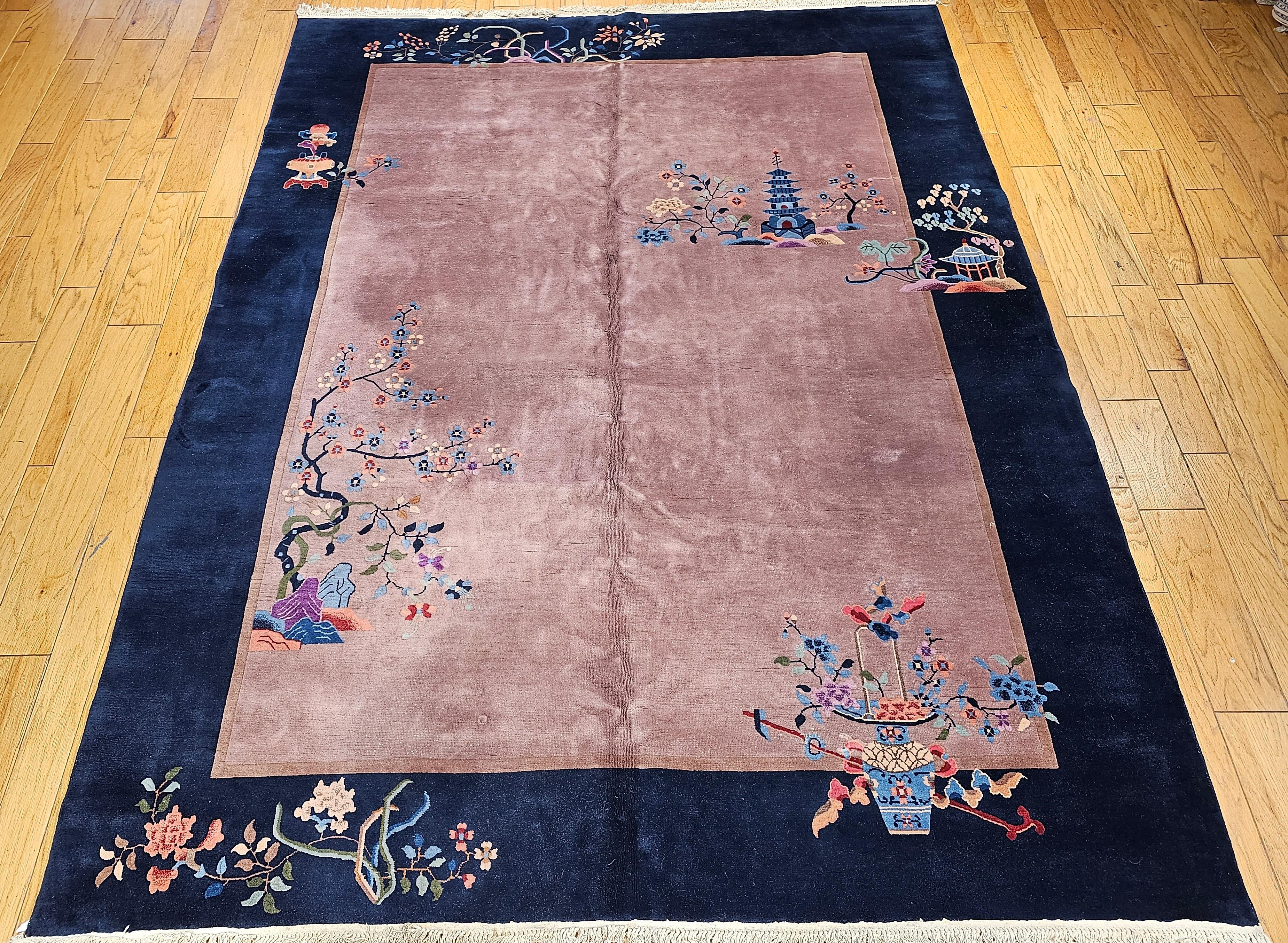 Breathtakingly Beautiful!  Vintage hand-knotted Chinese Art Deco Nichols room size rug with a floral design on eggplant or pale mauve color field with a dark blue border from the early 1900s.   It has the floral design of trees and flowers, and