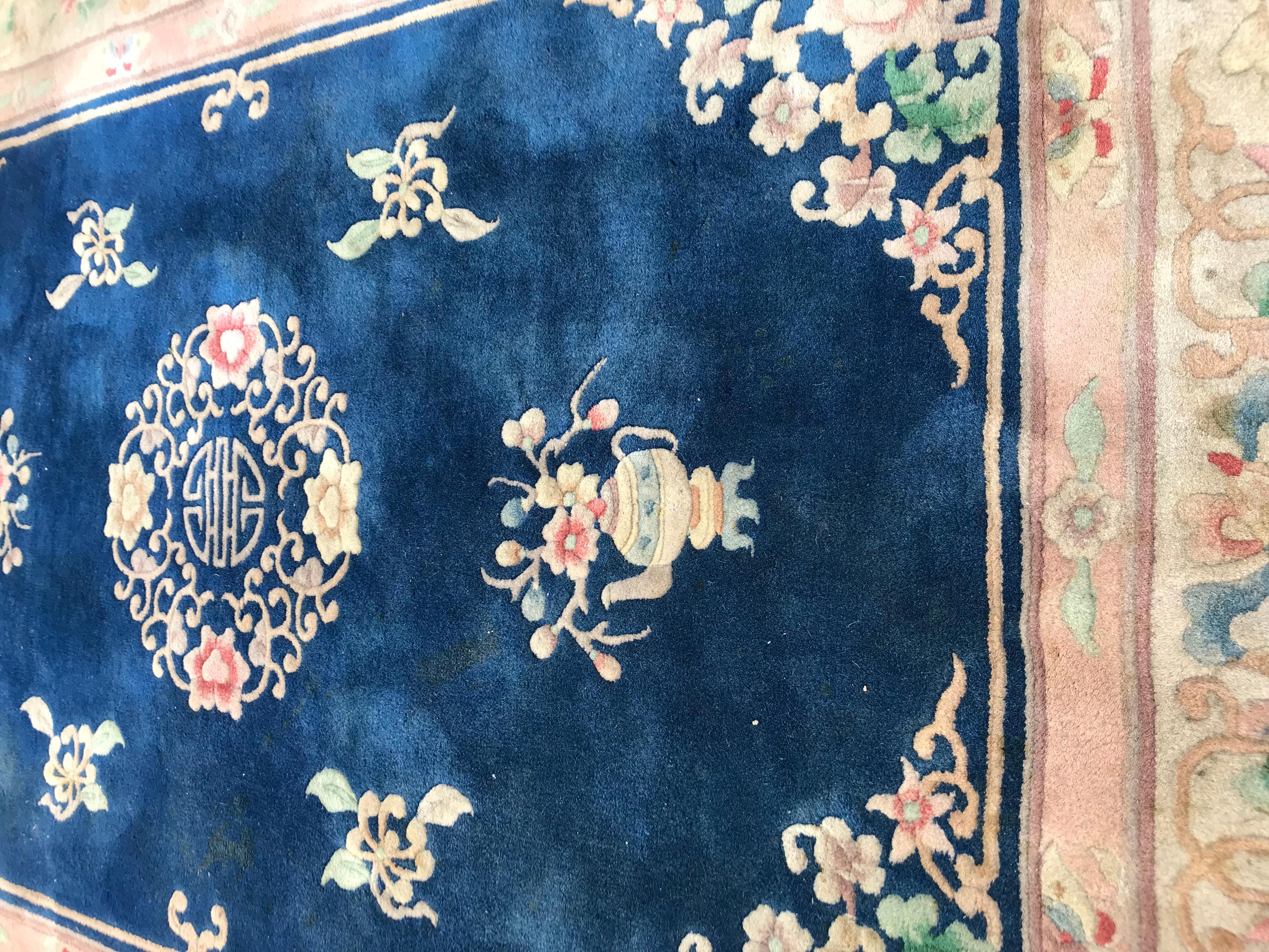 Beautiful vintage late 20th century Chinese rug with a Chinese and Art Deco design and blue field with pink, blue and green, entirely hand knotted with wool velvet on cotton foundation.