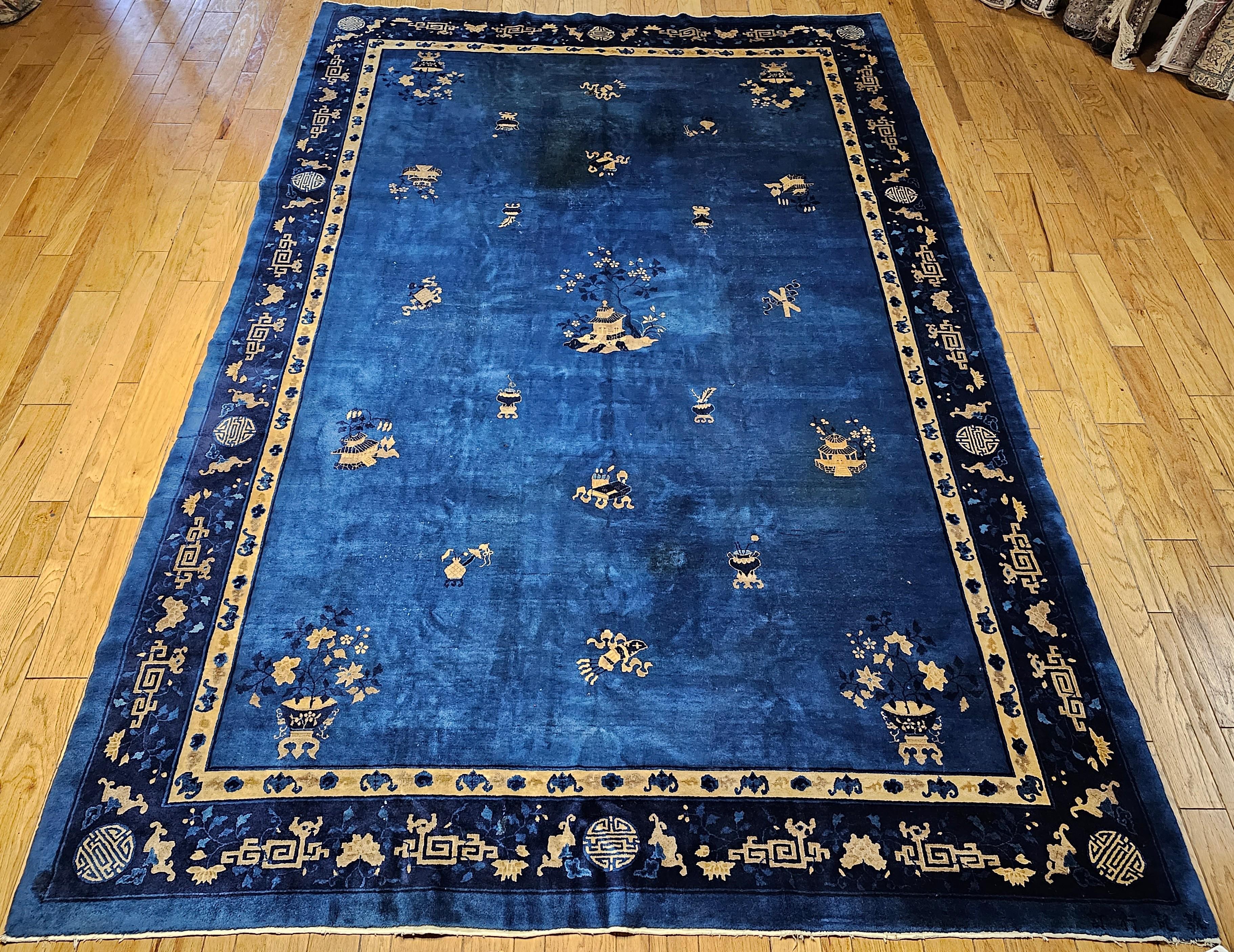 A beautiful Art Deco Chinese rug from the 1st quarter of the 1900s. The rug would bring in elegance through its understatement.  The rug has a Royal Blue color field with auspicious objects and symbols including incense burners, potted plants,