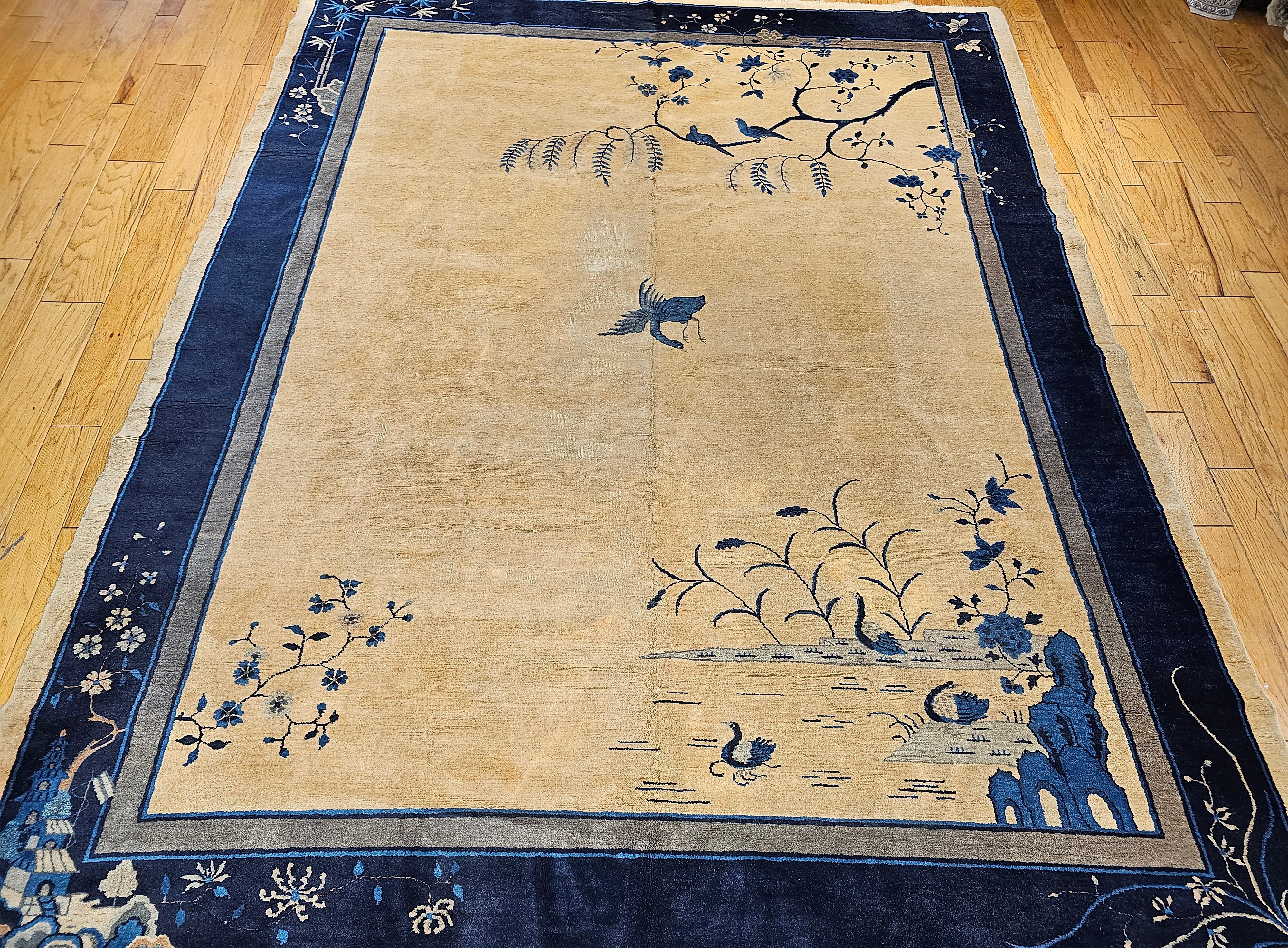 Early 20th Century Art Deco Chinese rug with a natural wheat or straw (light beige) color field and gray and blue color borders. The design includes a single crane in the center, the pagoda in the corner, mountains, a river, and birds on a tree