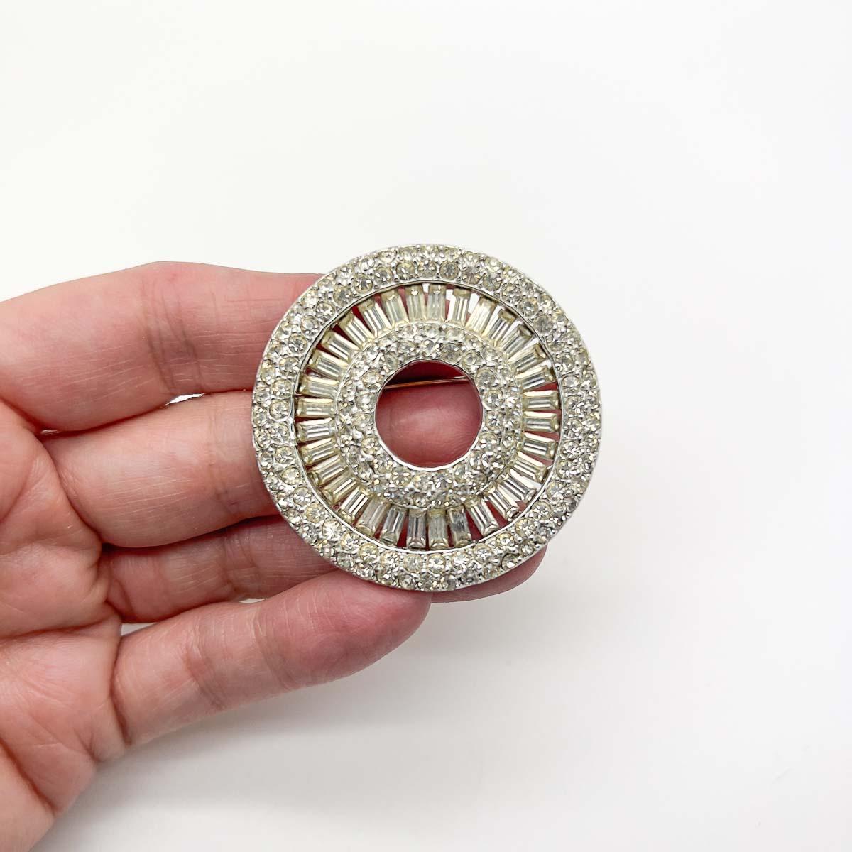 A wonderfully chic Vintage Art Deco Target Brooch. Crafted and designed to perfection with layers of crystals including baguette stones to make an ultra glamorous and eternally stylish statement.
An unsigned beauty. A rare treasure. Just because a